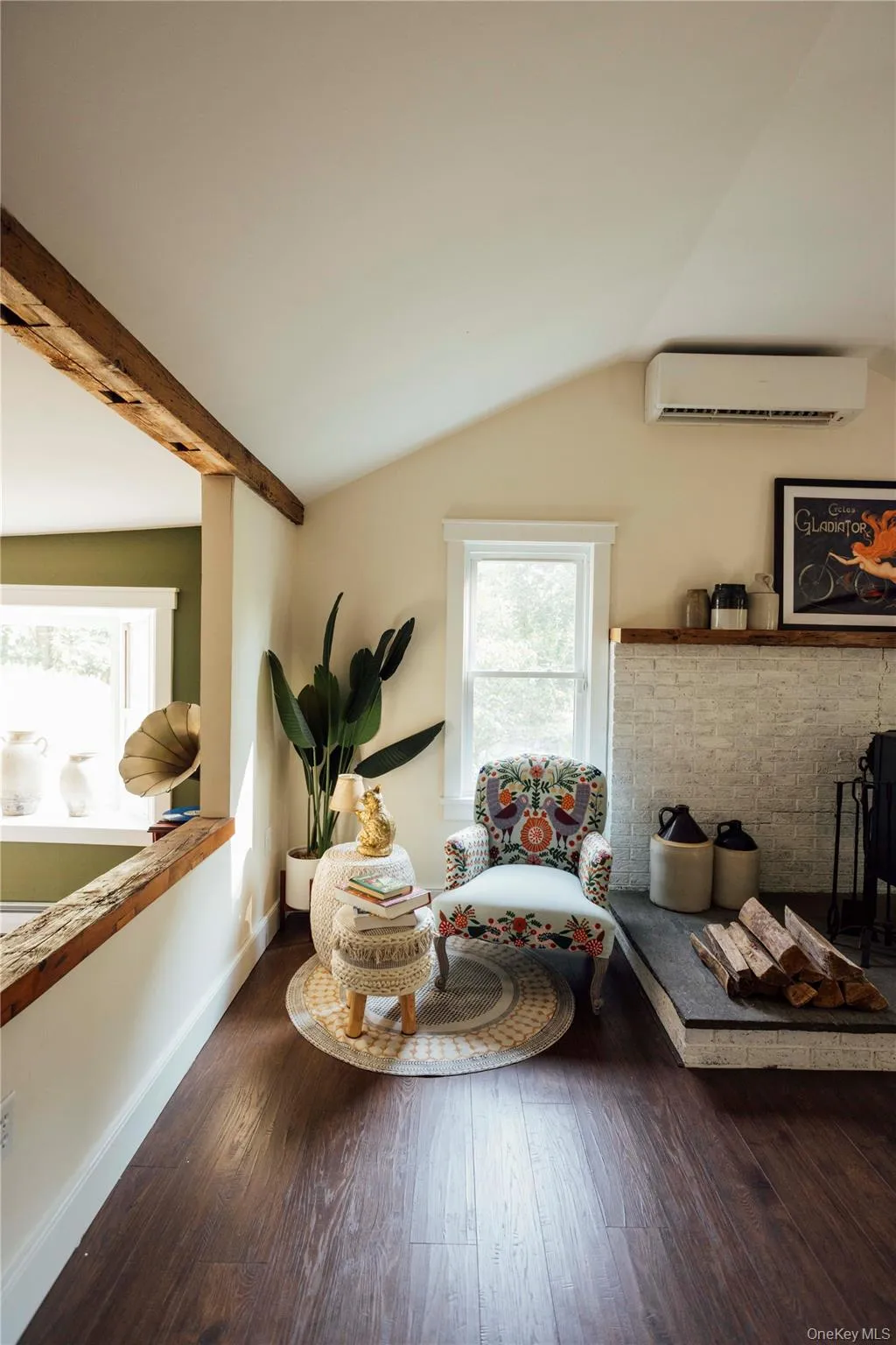 Sitting room featuring wood-type flooring and a wall unit AC Sitting room featuring wood-type flooring and a wall unit AC