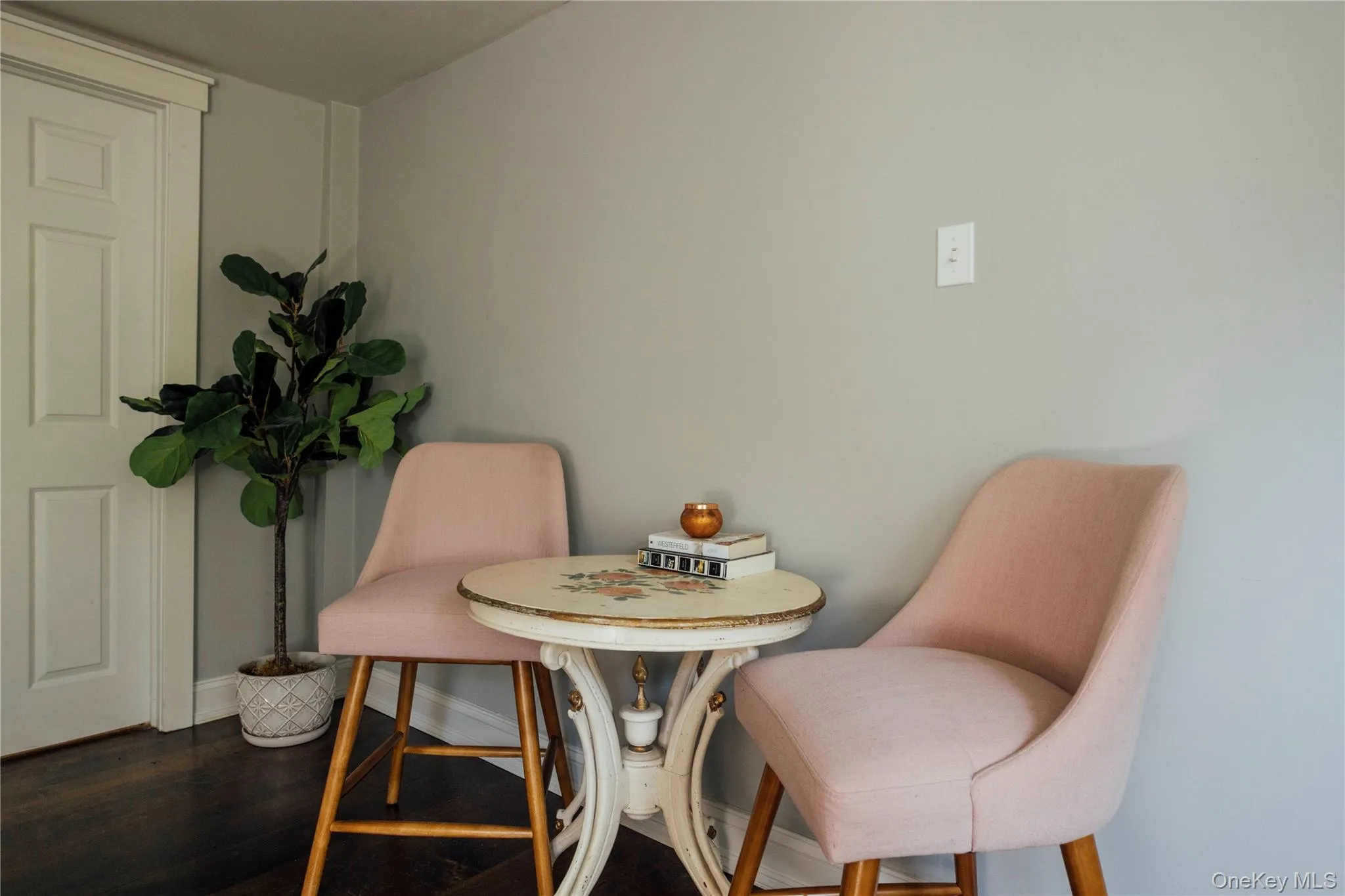 Living area with wood finished floors and baseboards Living area with wood finished floors and baseboards