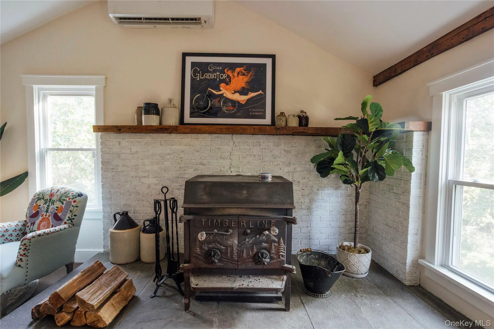 Detailed view of a wall mounted air conditioner, a wood stove, and wood finished floors Detailed view of a wall mounted air conditioner, a wood stove, and wood finished floors
