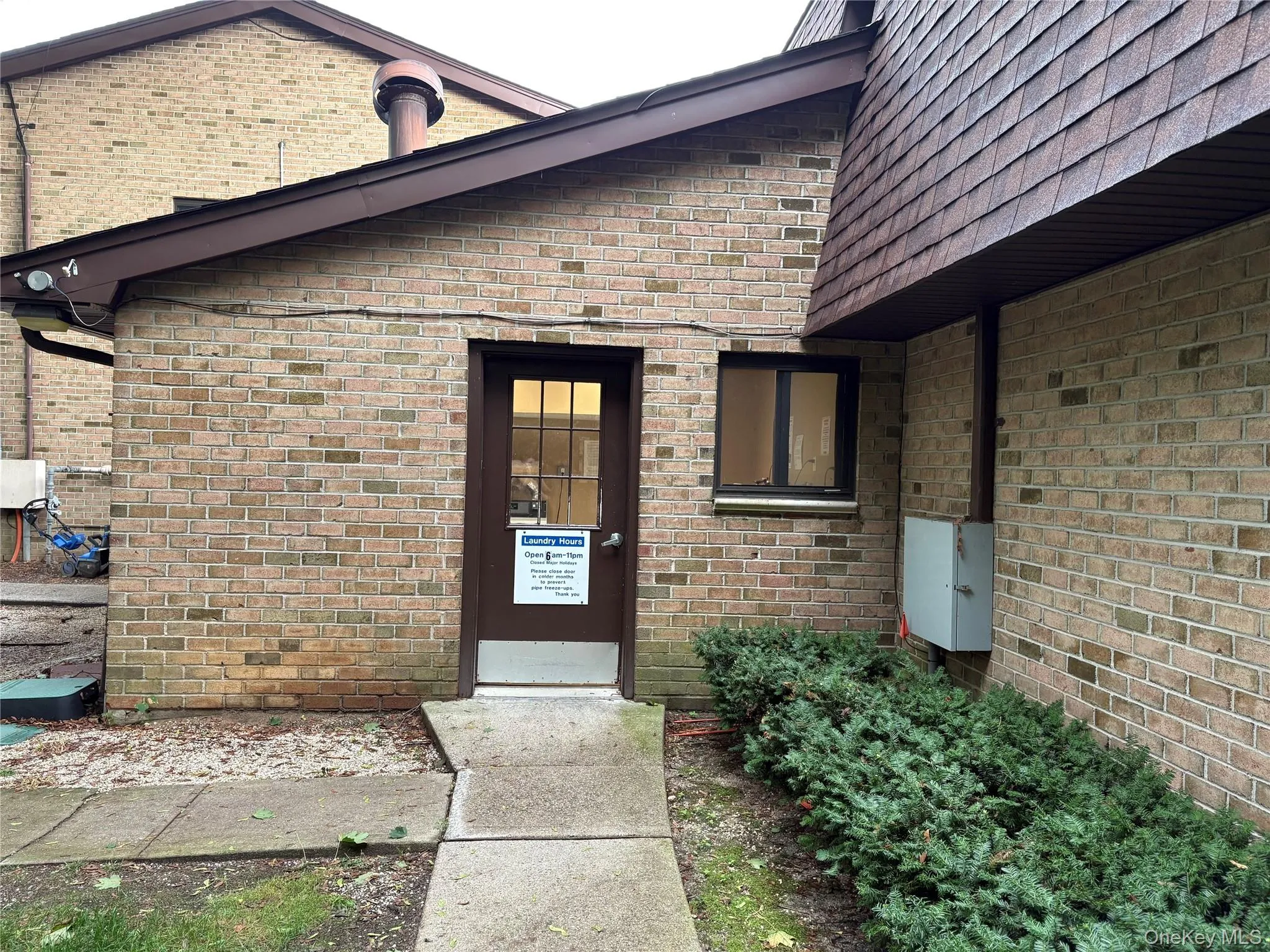 Property entrance with brick siding Property entrance with brick siding