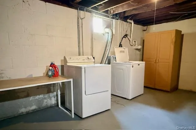 Laundry room with finished concrete flooring and washing machine and dryer Laundry room with finished concrete flooring and washing machine and dryer