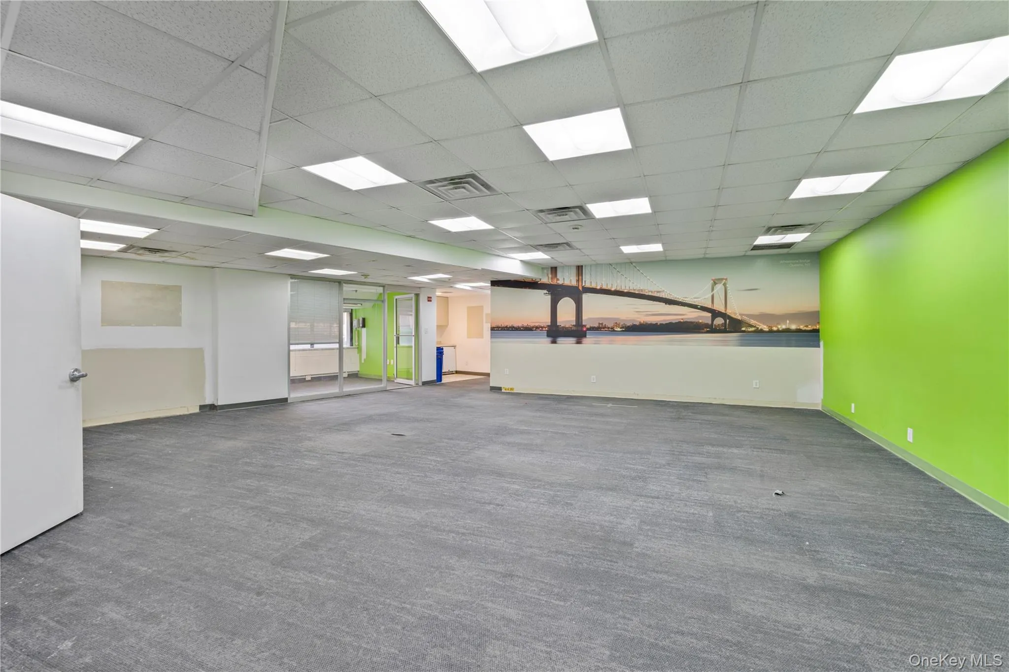 Spare room with a drop ceiling and dark colored carpet Spare room with a drop ceiling and dark colored carpet