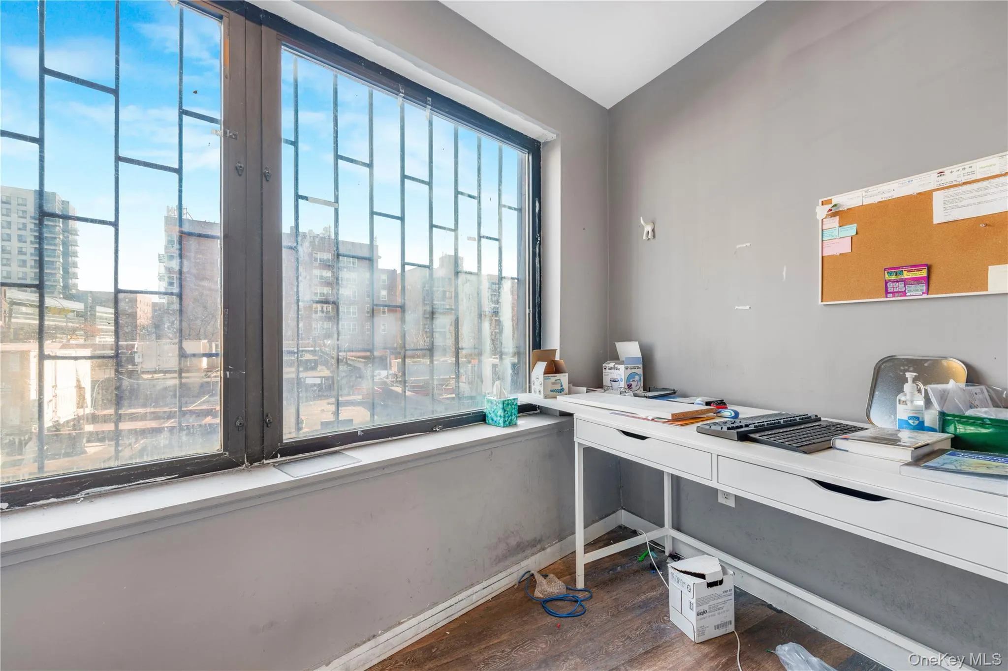 Home office with wood finished floors and a view of city Home office with wood finished floors and a view of city