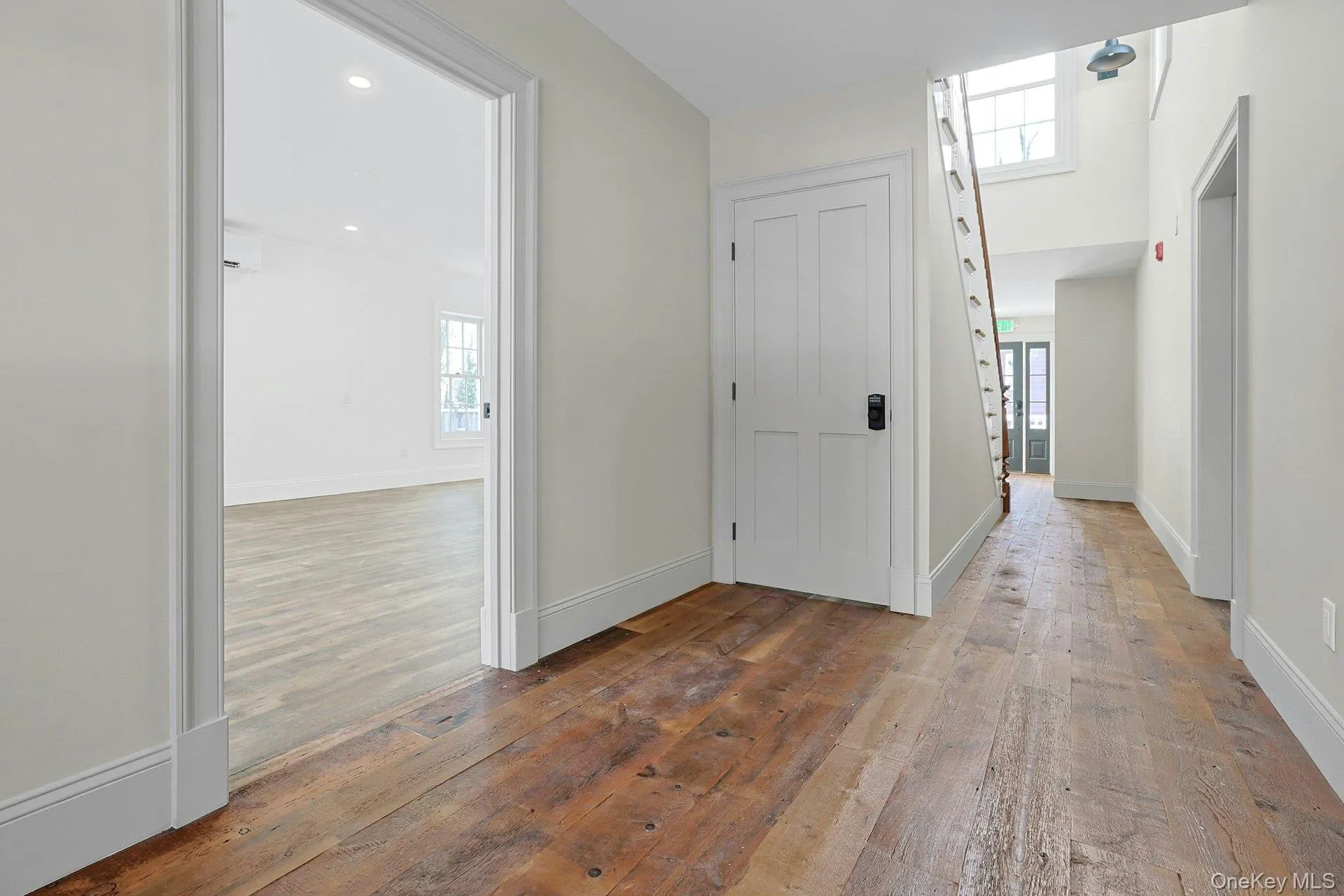 Corridor with plenty of natural light and light wood finished floors Corridor with plenty of natural light and light wood finished floors