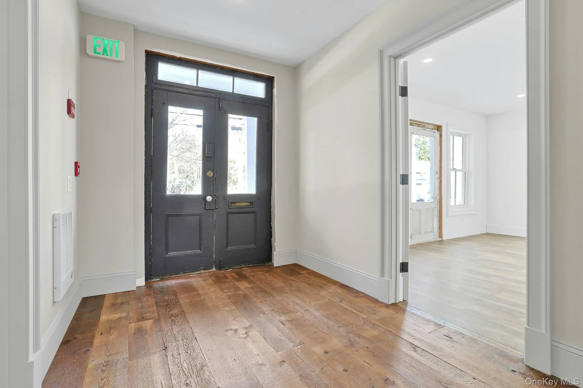 Entrance foyer featuring hardwood / wood-style flooring and baseboards Entrance foyer featuring hardwood / wood-style flooring and baseboards