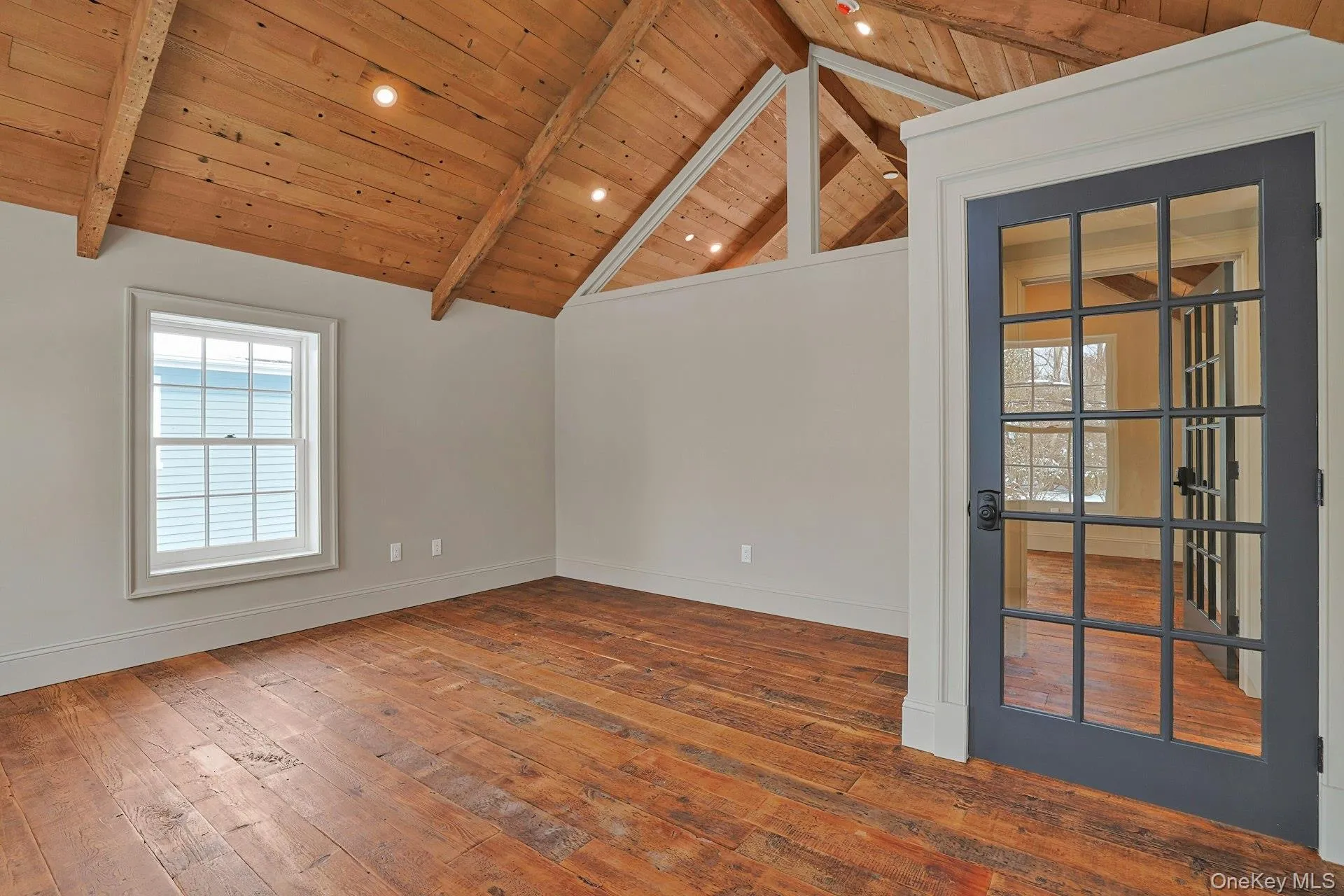 Unfurnished room featuring hardwood / wood-style floors and wood ceiling Unfurnished room featuring hardwood / wood-style floors and wood ceiling