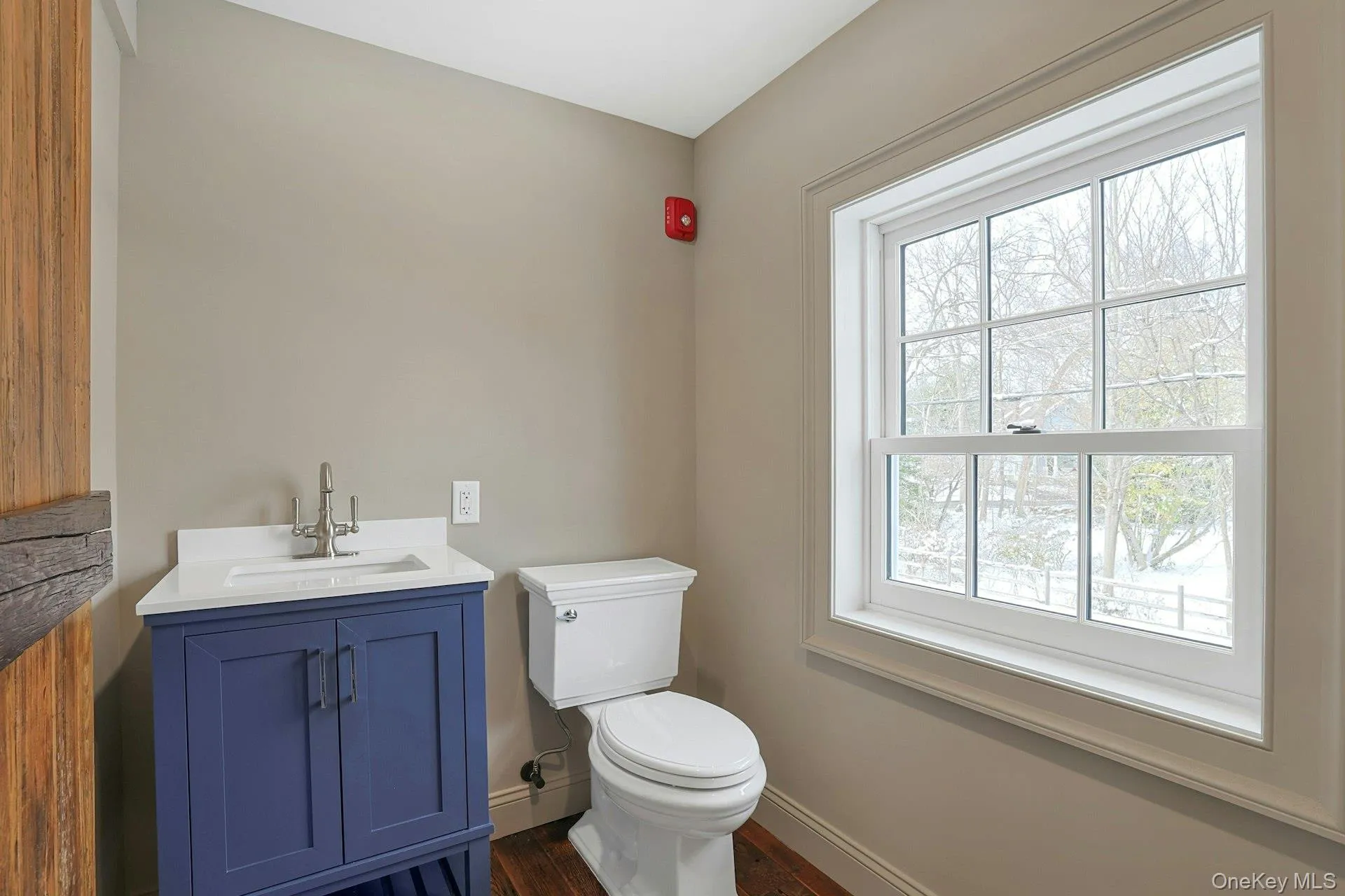 Half bath featuring vanity and dark wood-type flooring Half bath featuring vanity and dark wood-type flooring