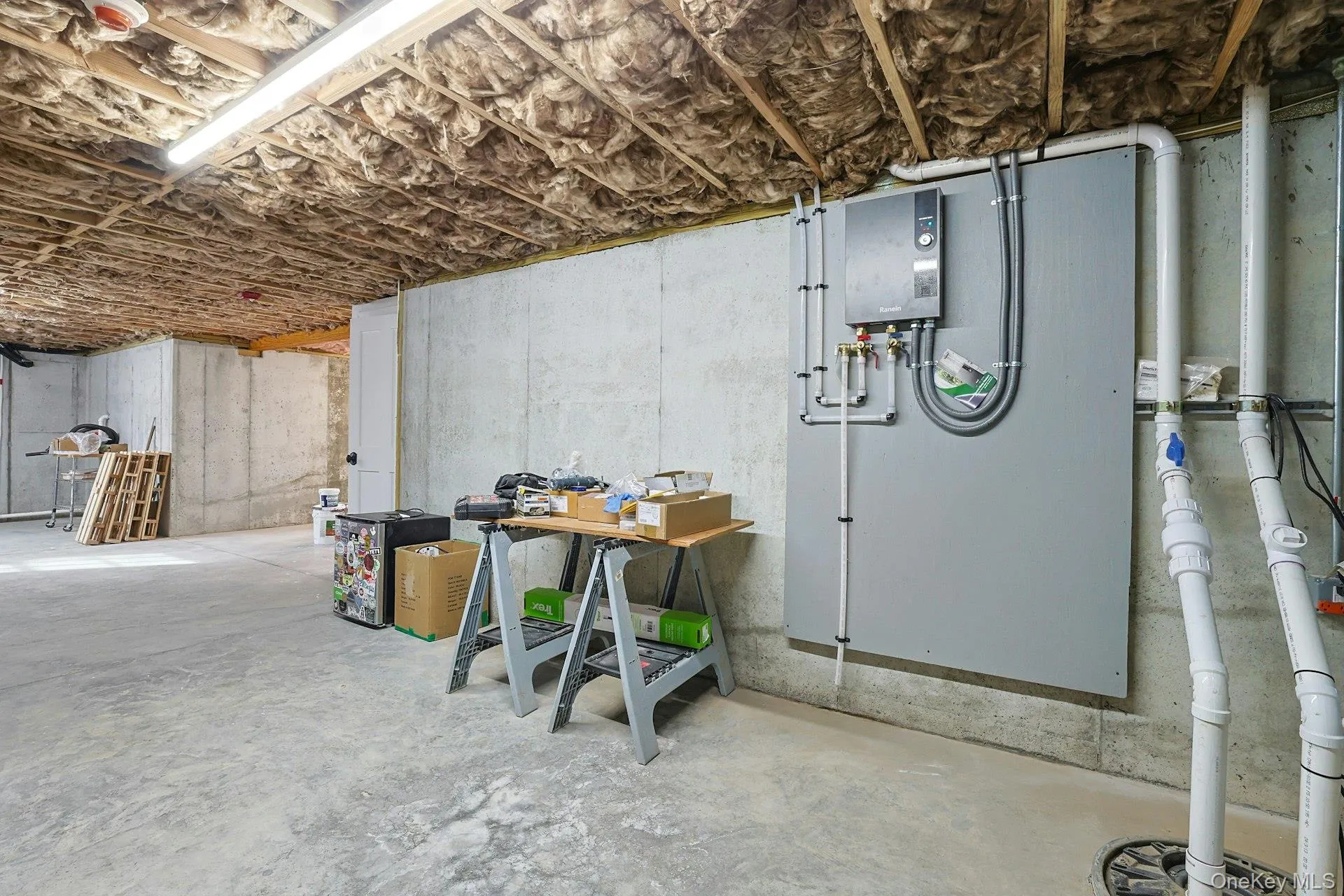 Unfinished basement with water heater Unfinished basement with water heater