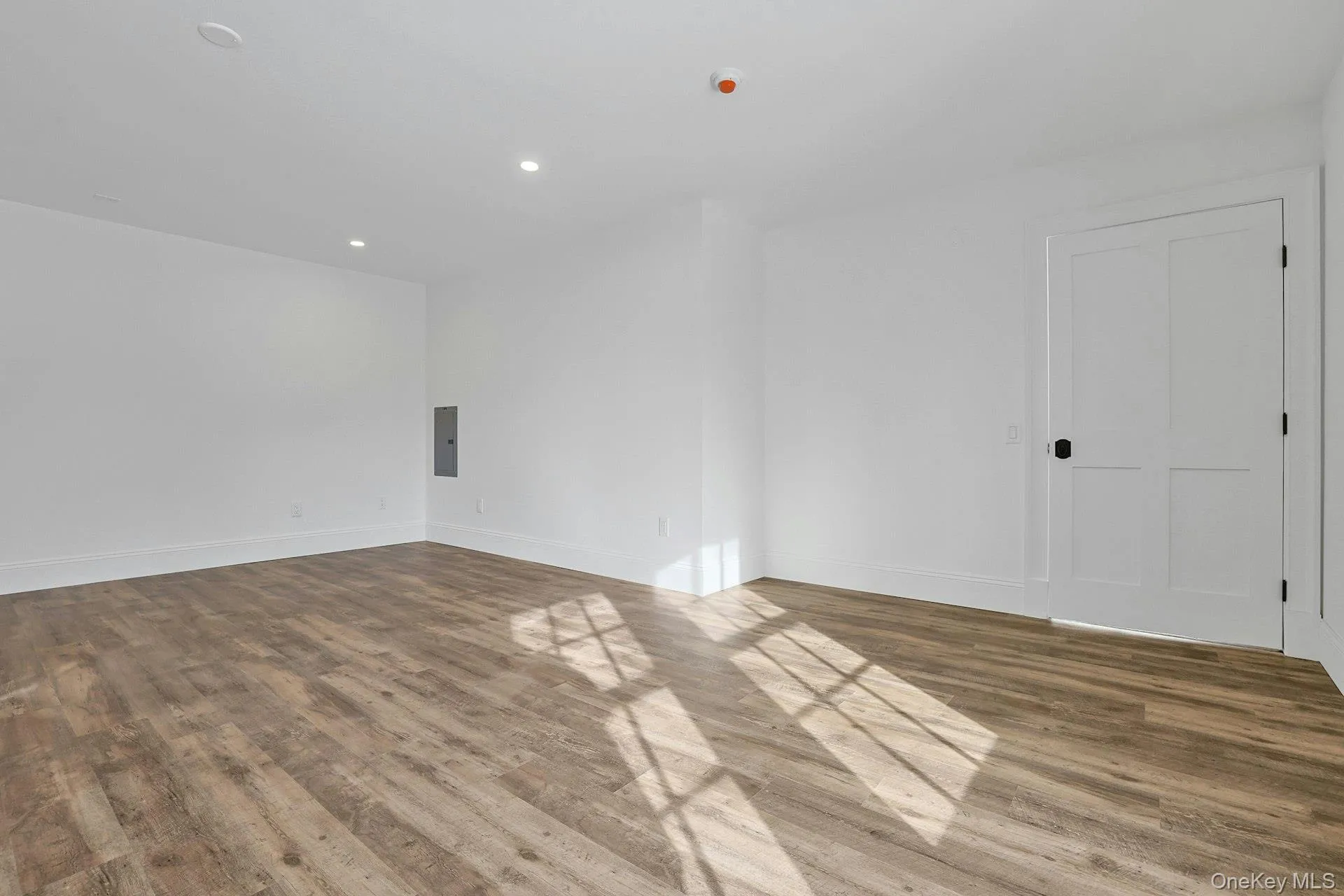 Spare room featuring wood finished floors, recessed lighting, and electric panel Spare room featuring wood finished floors, recessed lighting, and electric panel