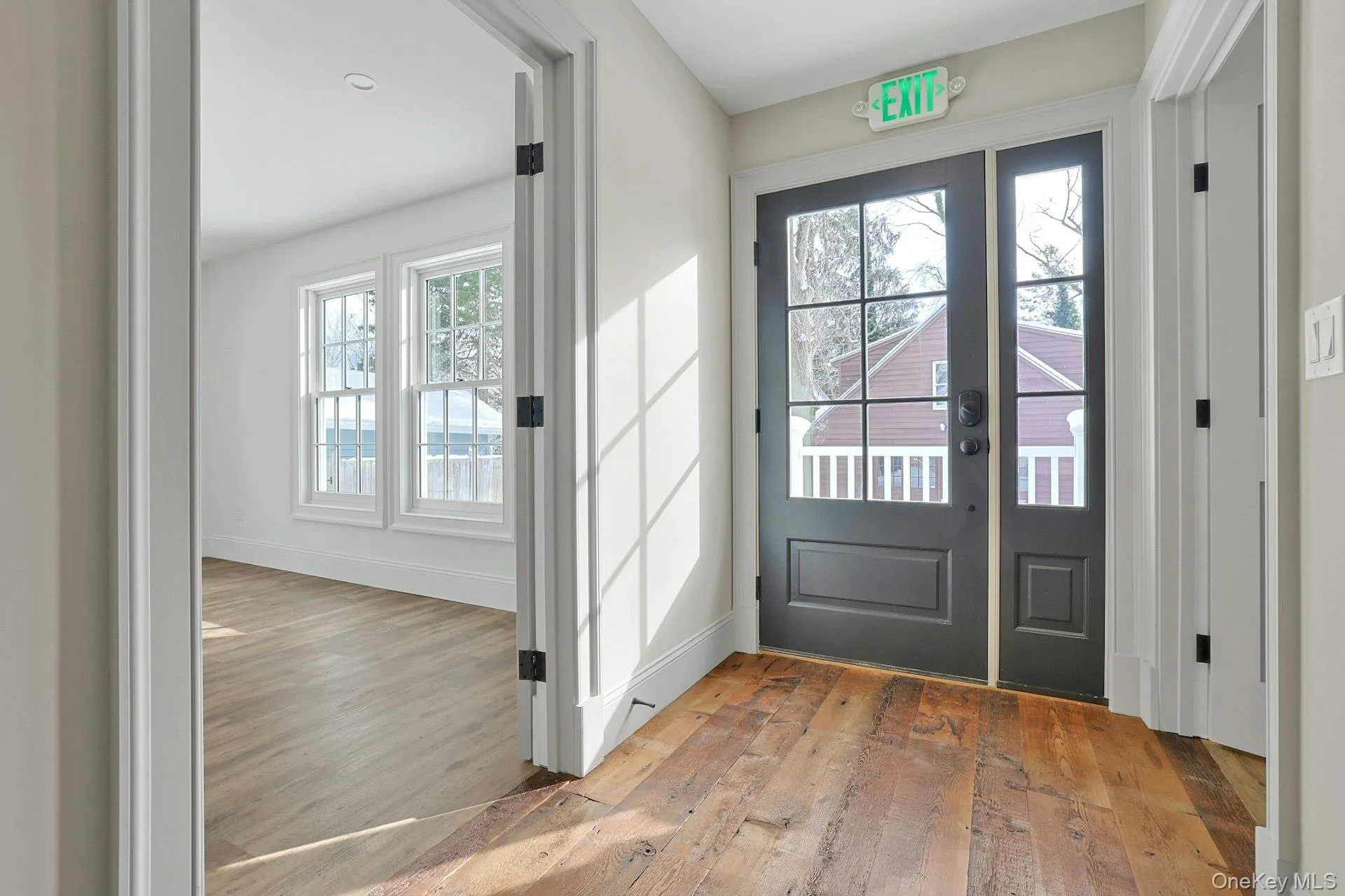 Foyer entrance featuring hardwood / wood-style floors and baseboards Foyer entrance featuring hardwood / wood-style floors and baseboards