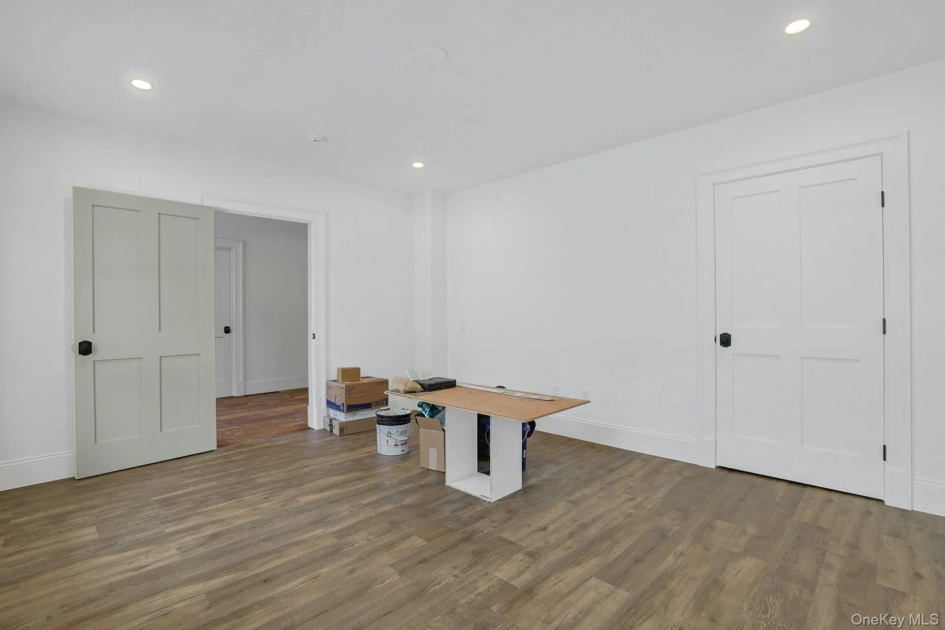 Unfurnished office with wood finished floors and recessed lighting Unfurnished office with wood finished floors and recessed lighting