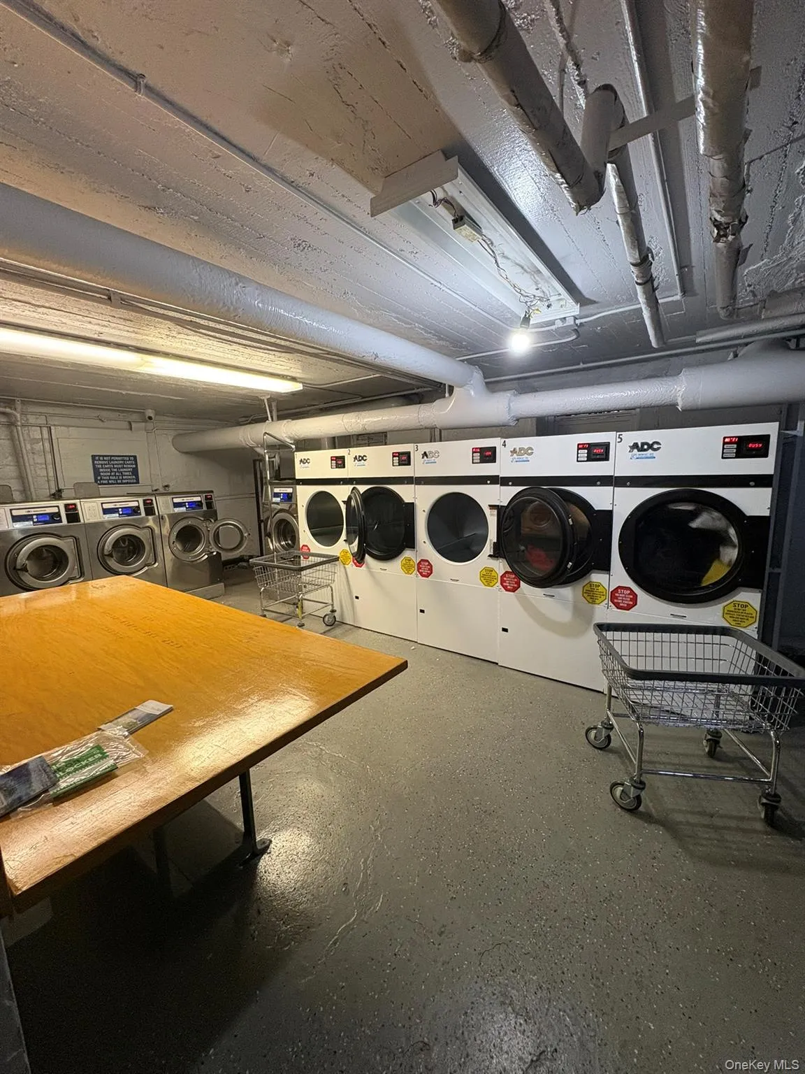 Shared laundry room featuring washing machine and dryer Shared laundry room featuring washing machine and dryer