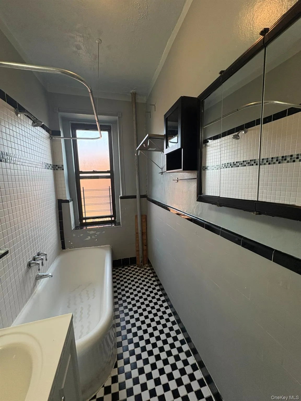Full bathroom featuring vanity, dark flooring, and shower combination Full bathroom featuring vanity, dark flooring, and shower combination
