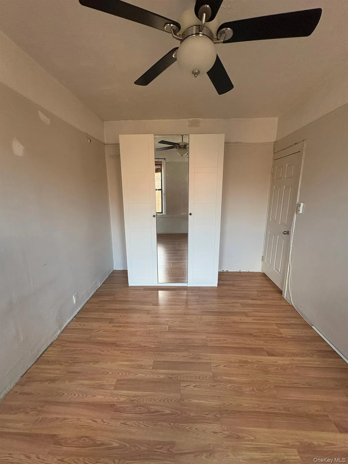 Unfurnished bedroom featuring light wood-style floors and ceiling fan Unfurnished bedroom featuring light wood-style floors and ceiling fan