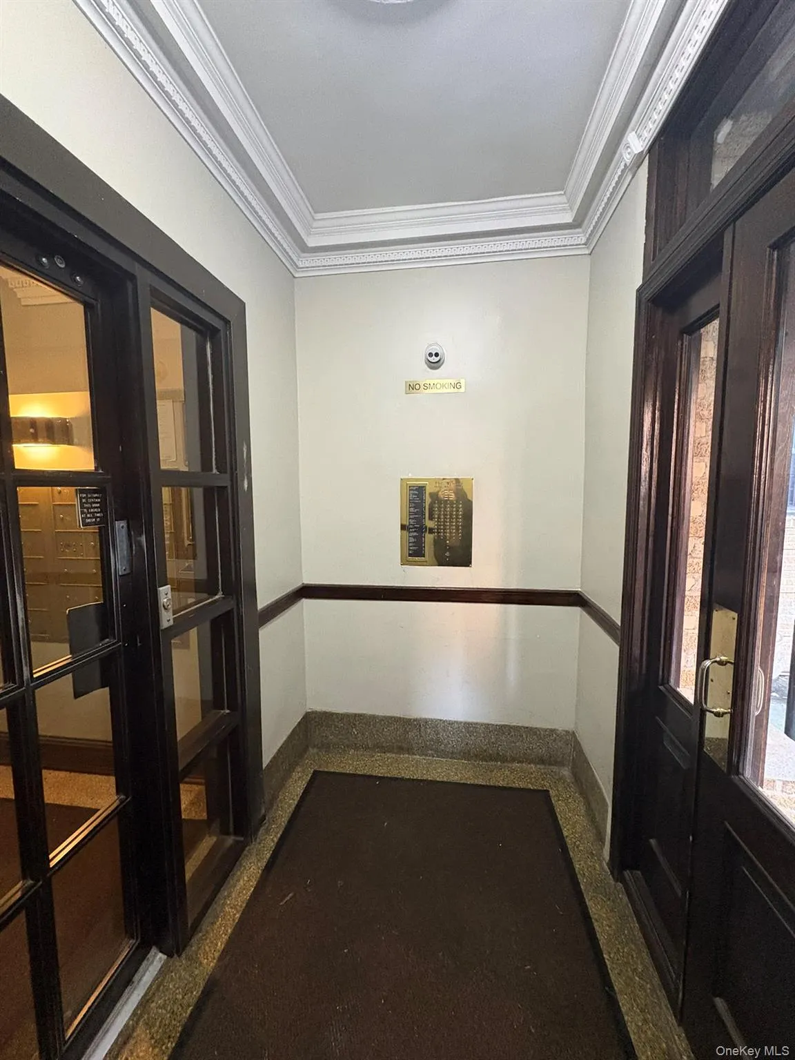 Corridor with crown molding and light speckled floor Corridor with crown molding and light speckled floor