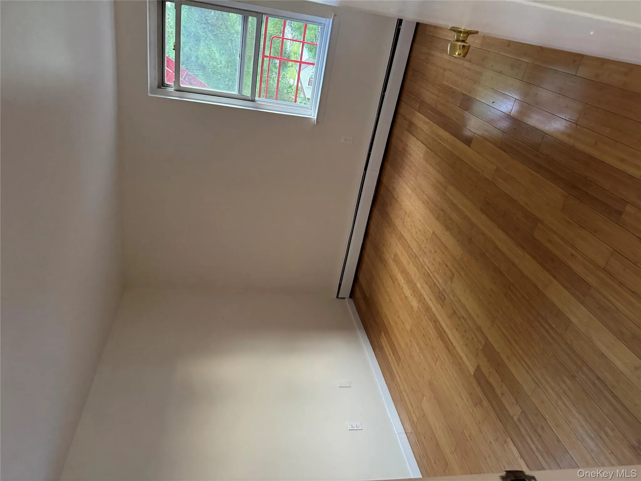 Spare room featuring a baseboard radiator and light wood-type flooring Spare room featuring a baseboard radiator and light wood-type flooring