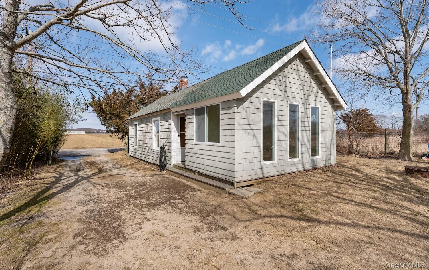 View of home's exterior featuring a chimney and roof with shingles View of home's exterior featuring a chimney and roof with shingles