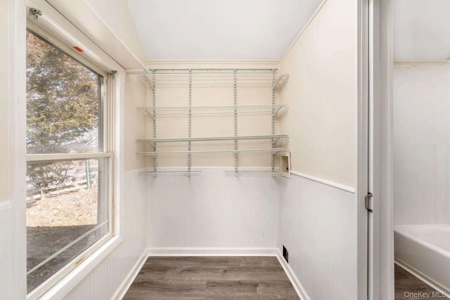 Walk in closet featuring dark wood finished floors Walk in closet featuring dark wood finished floors
