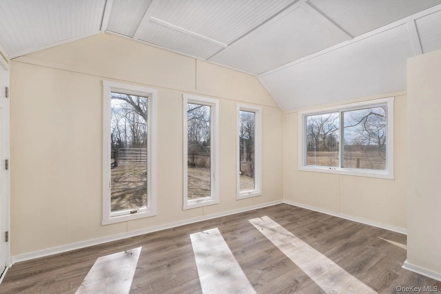 Additional living space with vaulted ceiling and wood finished floors Additional living space with vaulted ceiling and wood finished floors