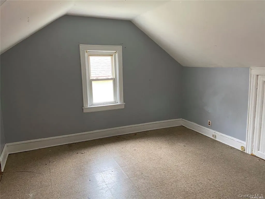 Additional living space with light floors and lofted ceiling Additional living space with light floors and lofted ceiling