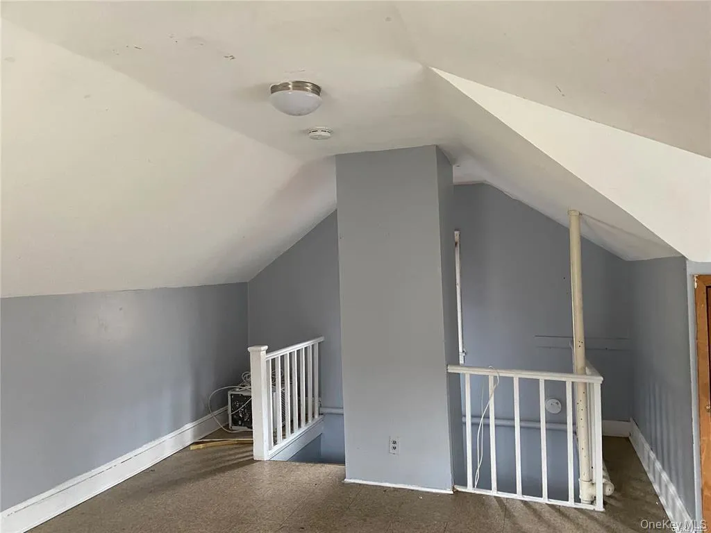 Additional living space featuring vaulted ceiling Additional living space featuring vaulted ceiling