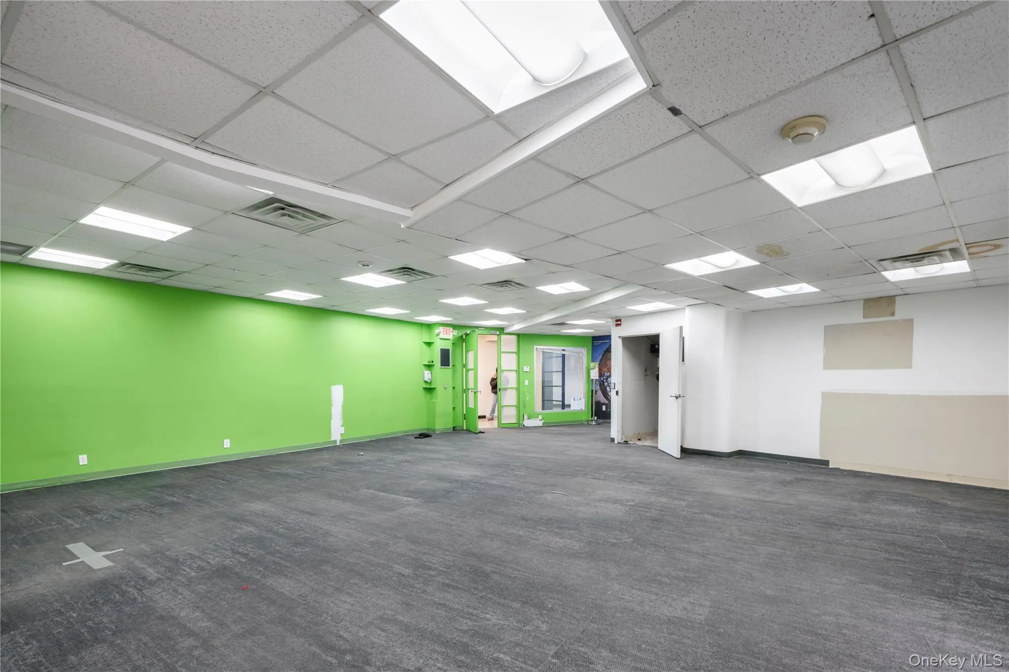 Empty room featuring dark carpet and baseboards Empty room featuring dark carpet and baseboards