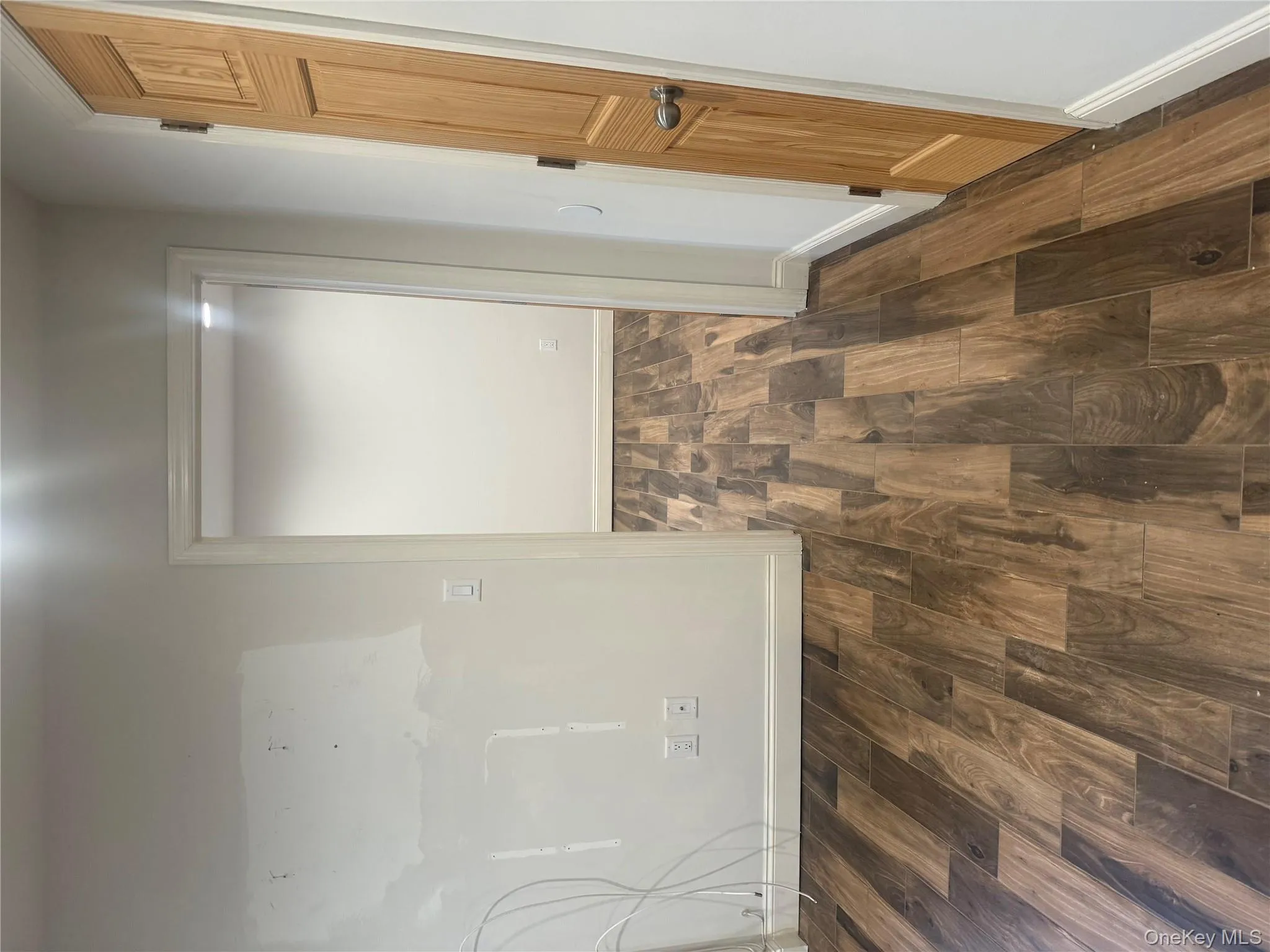 Corridor with dark wood-style flooring and baseboards Corridor with dark wood-style flooring and baseboards