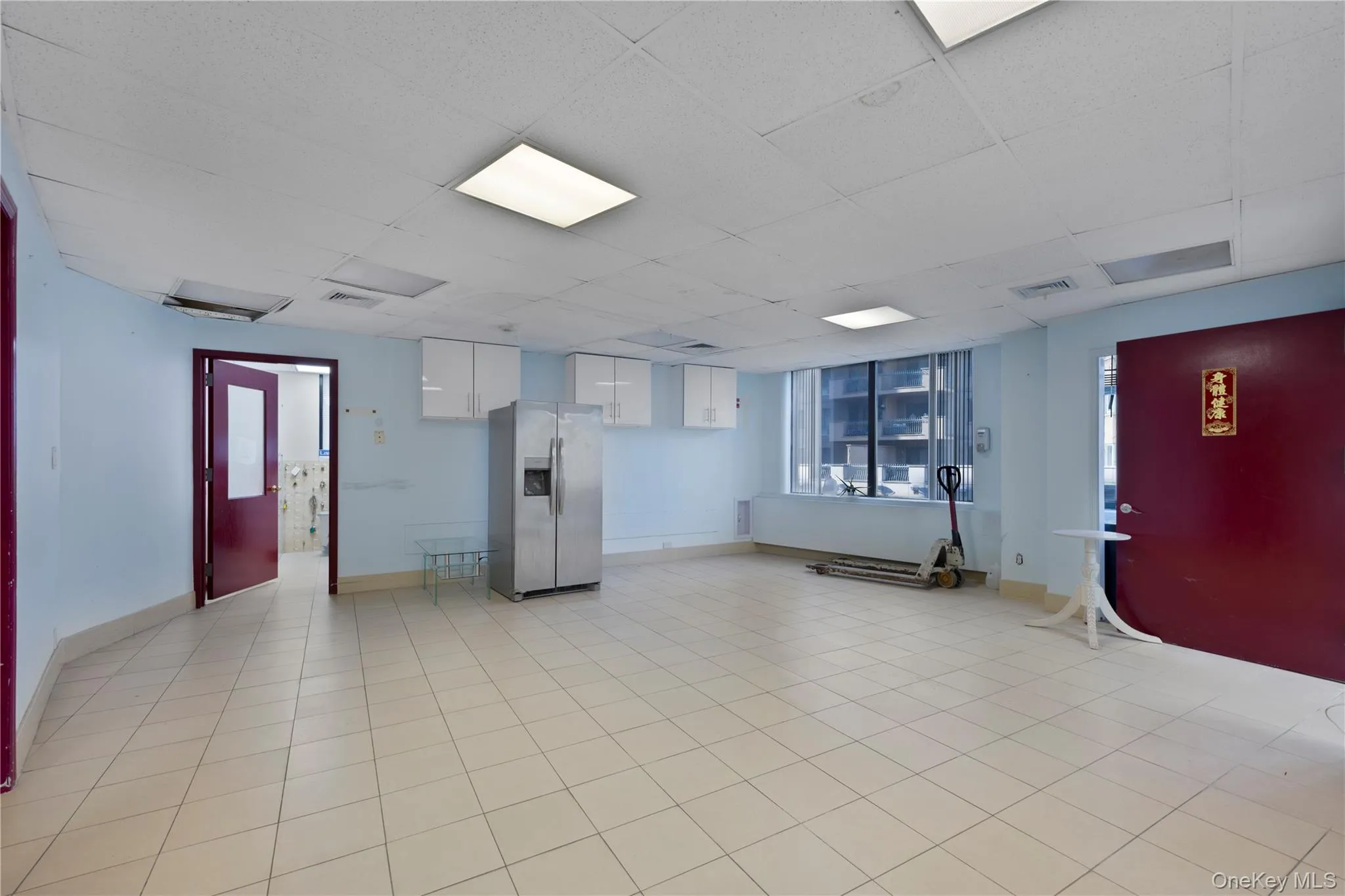 Unfurnished room featuring a drop ceiling and baseboards Unfurnished room featuring a drop ceiling and baseboards