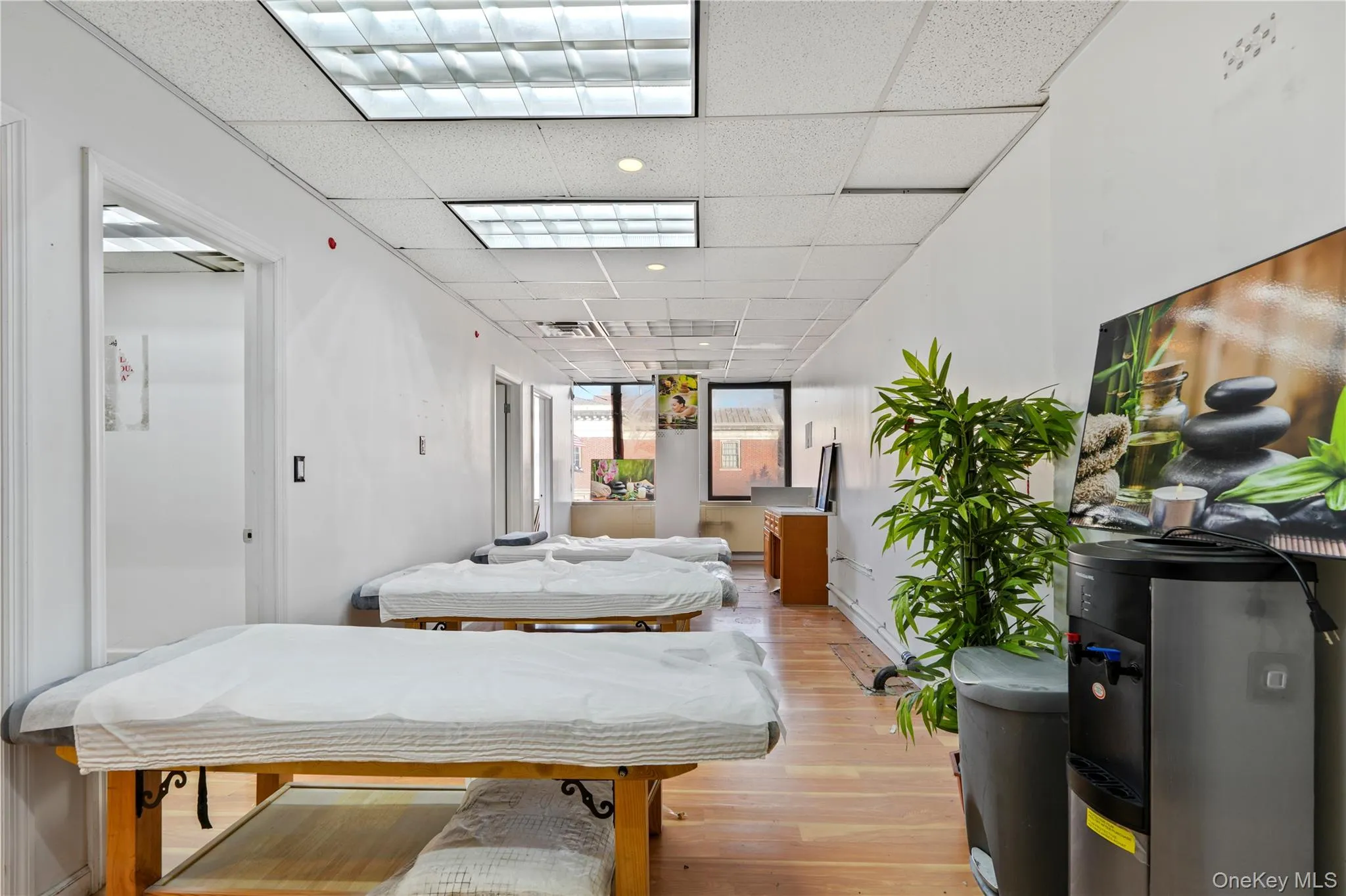 Bedroom with a paneled ceiling and light wood finished floors Bedroom with a paneled ceiling and light wood finished floors