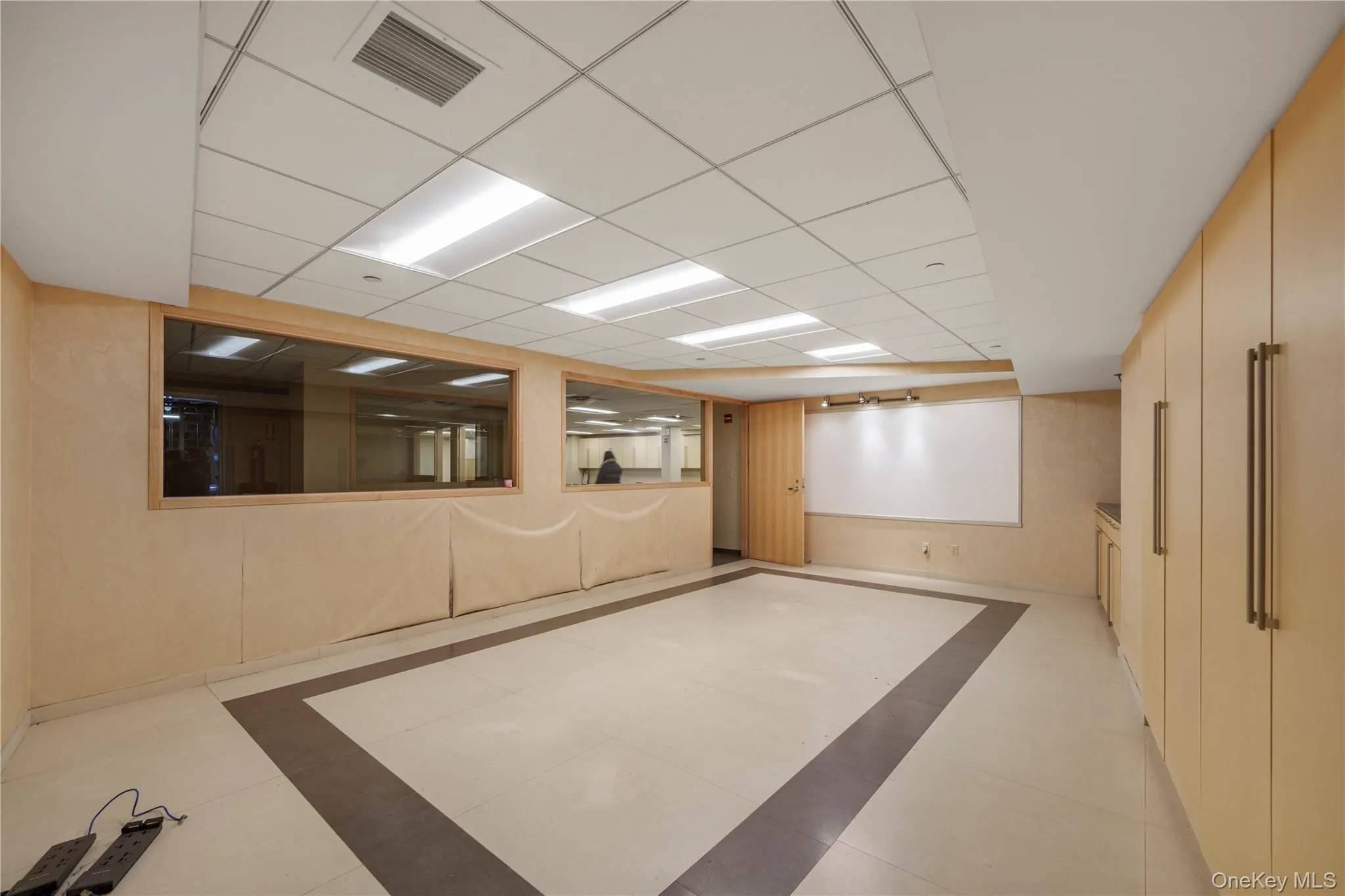 Finished basement with inlaid floor details and a drop ceiling Finished basement with inlaid floor details and a drop ceiling