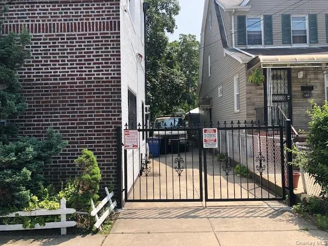 View of property exterior featuring brick siding and a gate View of property exterior featuring brick siding and a gate