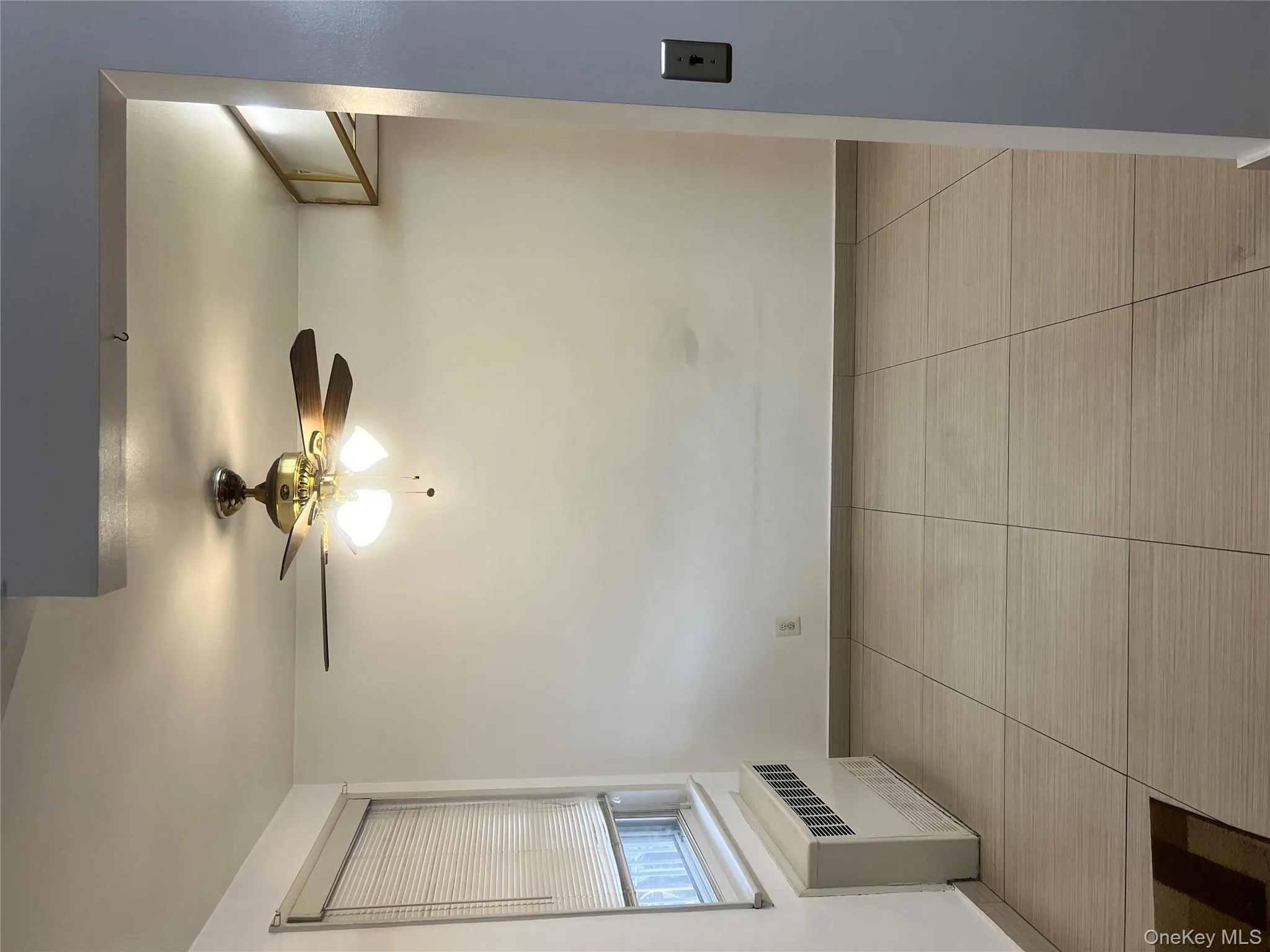Spare room with radiator heating unit and a ceiling fan Spare room with radiator heating unit and a ceiling fan
