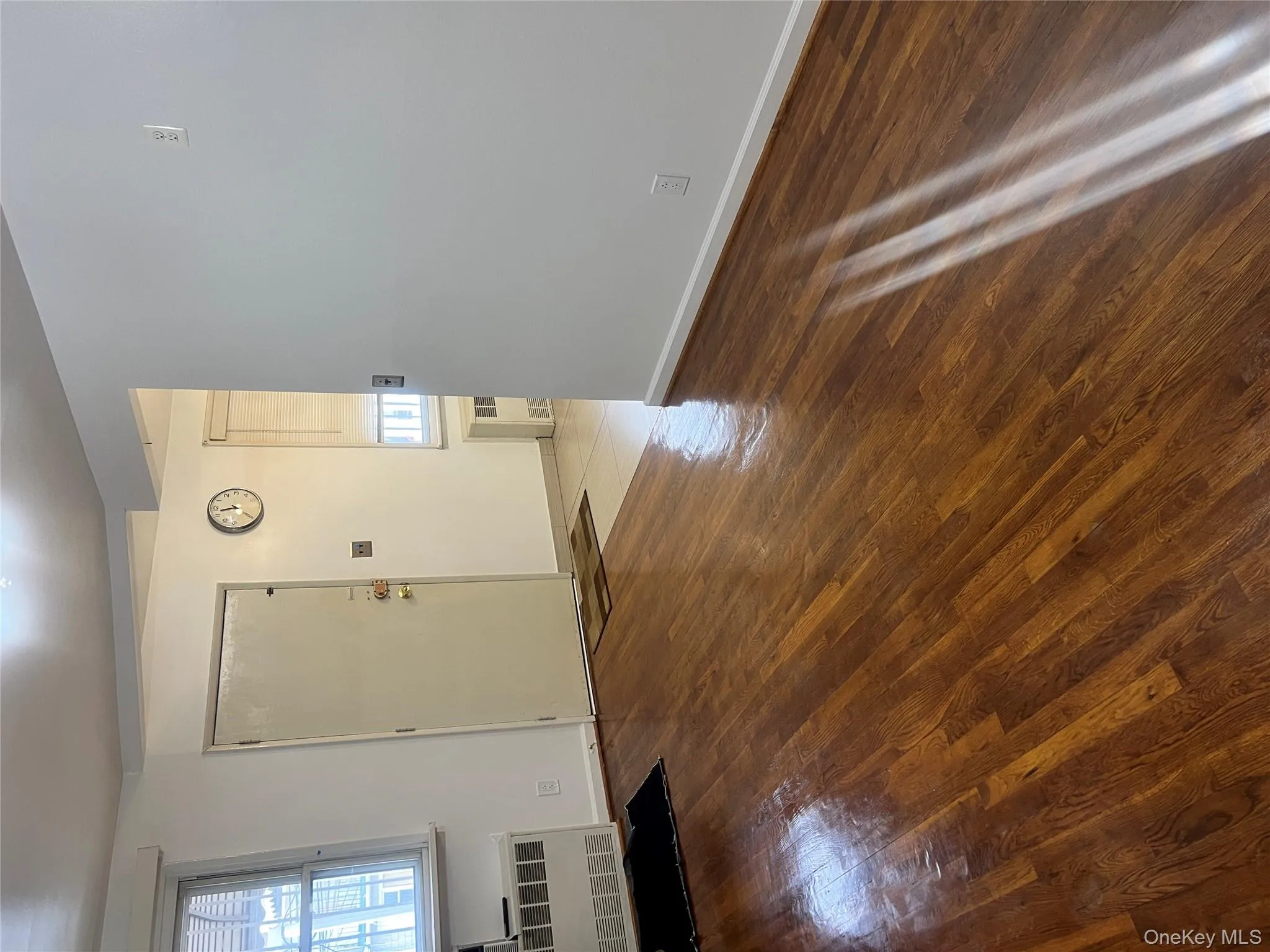 Foyer with dark wood-type flooring and radiator Foyer with dark wood-type flooring and radiator