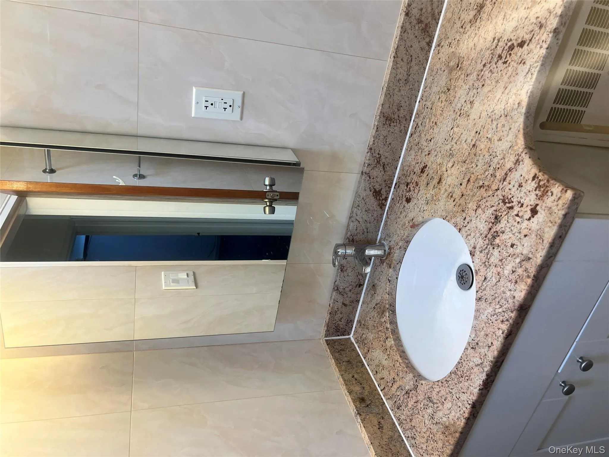 Bathroom featuring vanity and tile walls Bathroom featuring vanity and tile walls