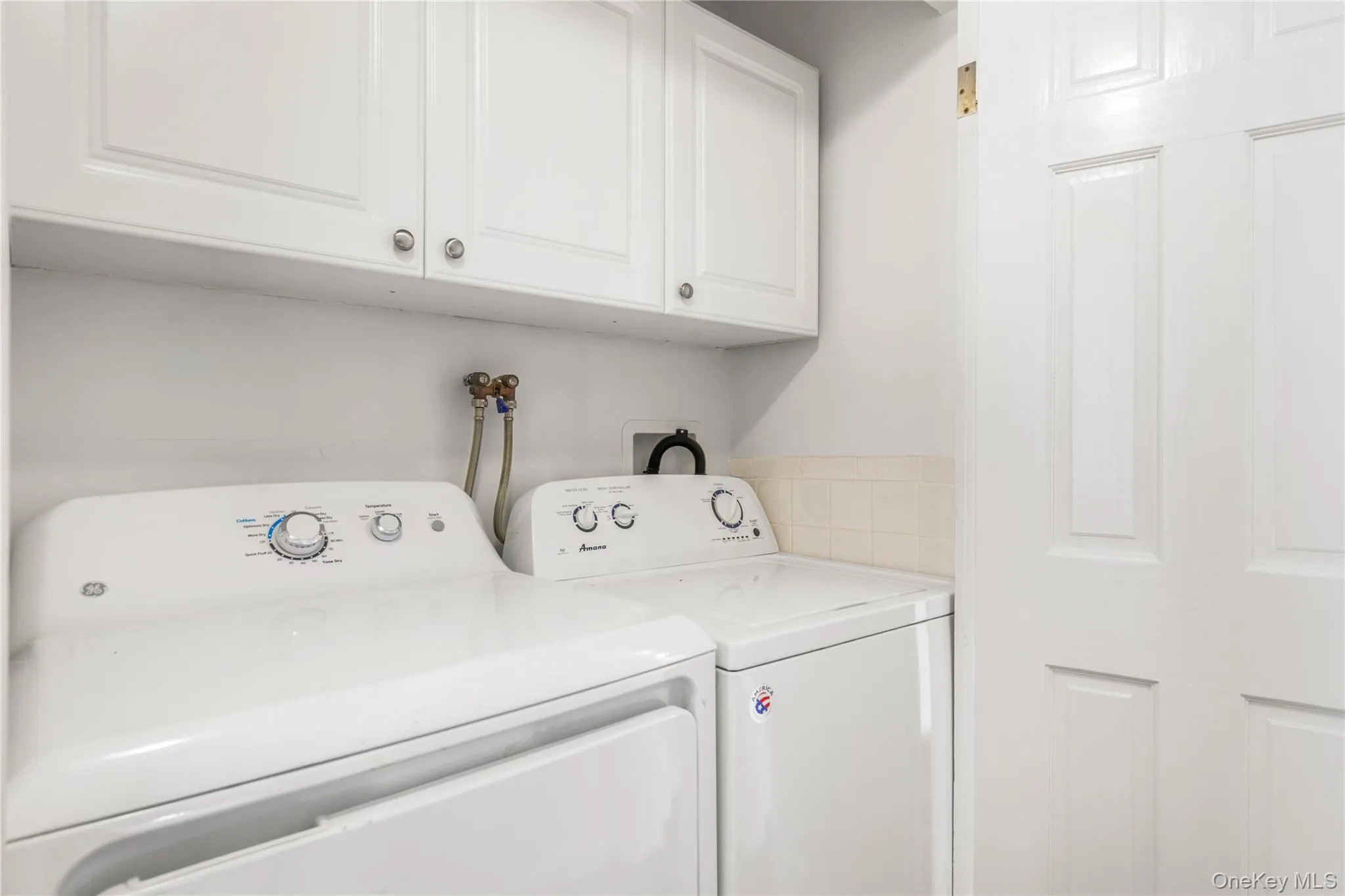Laundry area with cabinet space and washing machine and dryer Laundry area with cabinet space and washing machine and dryer