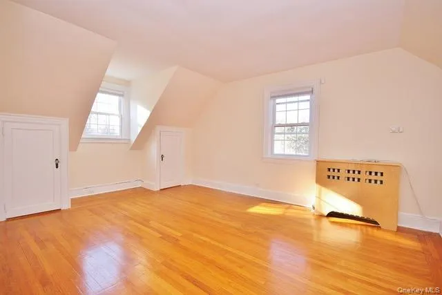 Bonus room with healthy amount of natural light, lofted ceiling, and light wood-type flooring Bonus room with healthy amount of natural light, lofted ceiling, and light wood-type flooring