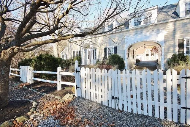 View of side of home with a fenced front yard and a gate View of side of home with a fenced front yard and a gate