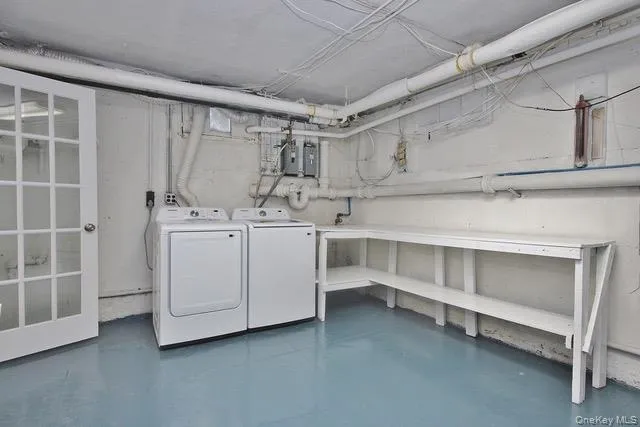 Unfinished below grade area featuring washer and dryer Unfinished below grade area featuring washer and dryer