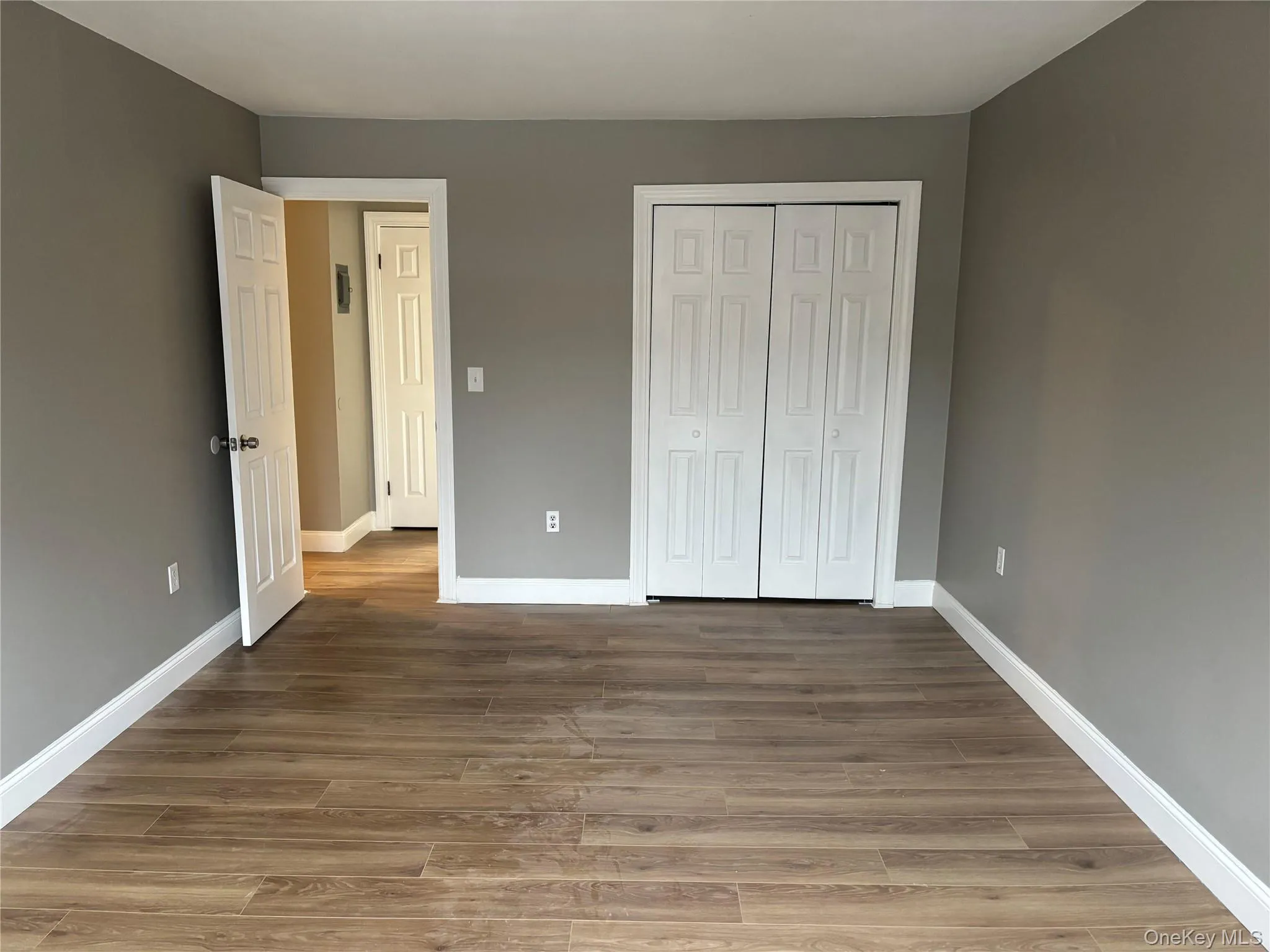 Unfurnished bedroom with light wood-type flooring and a closet Unfurnished bedroom with light wood-type flooring and a closet