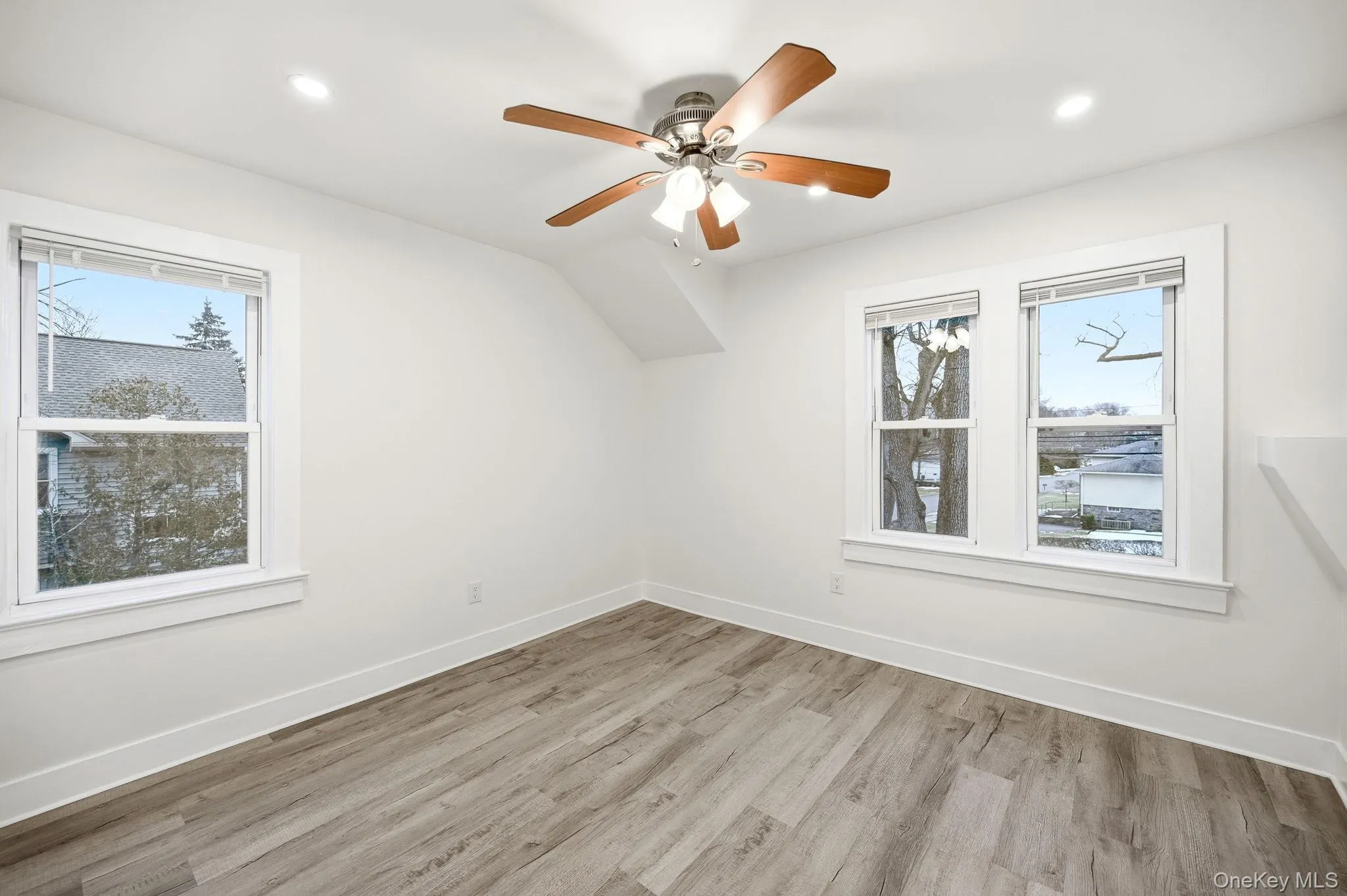 Bonus room with light wood-style floors, plenty of natural light, ceiling fan, and recessed lighting Bonus room with light wood-style floors, plenty of natural light, ceiling fan, and recessed lighting
