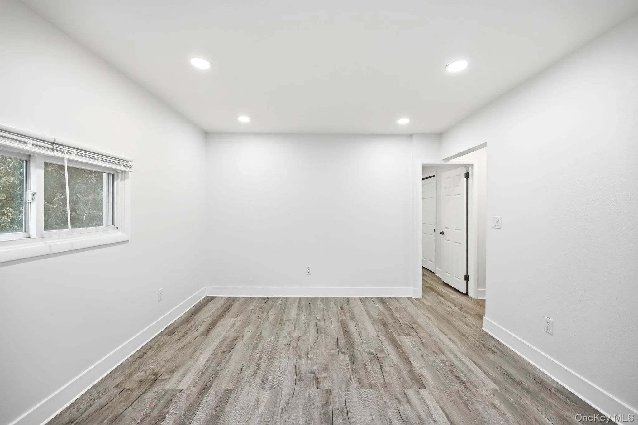 Empty room featuring light wood-style floors and recessed lighting Empty room featuring light wood-style floors and recessed lighting