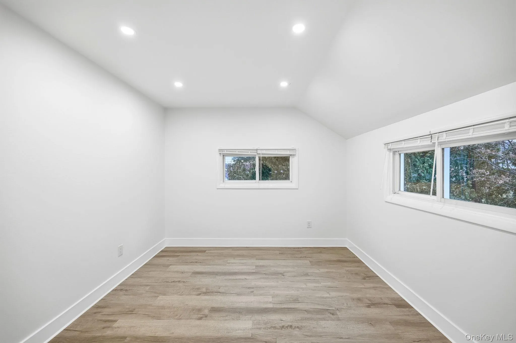 Bonus room with recessed lighting, light wood-style floors, and lofted ceiling Bonus room with recessed lighting, light wood-style floors, and lofted ceiling