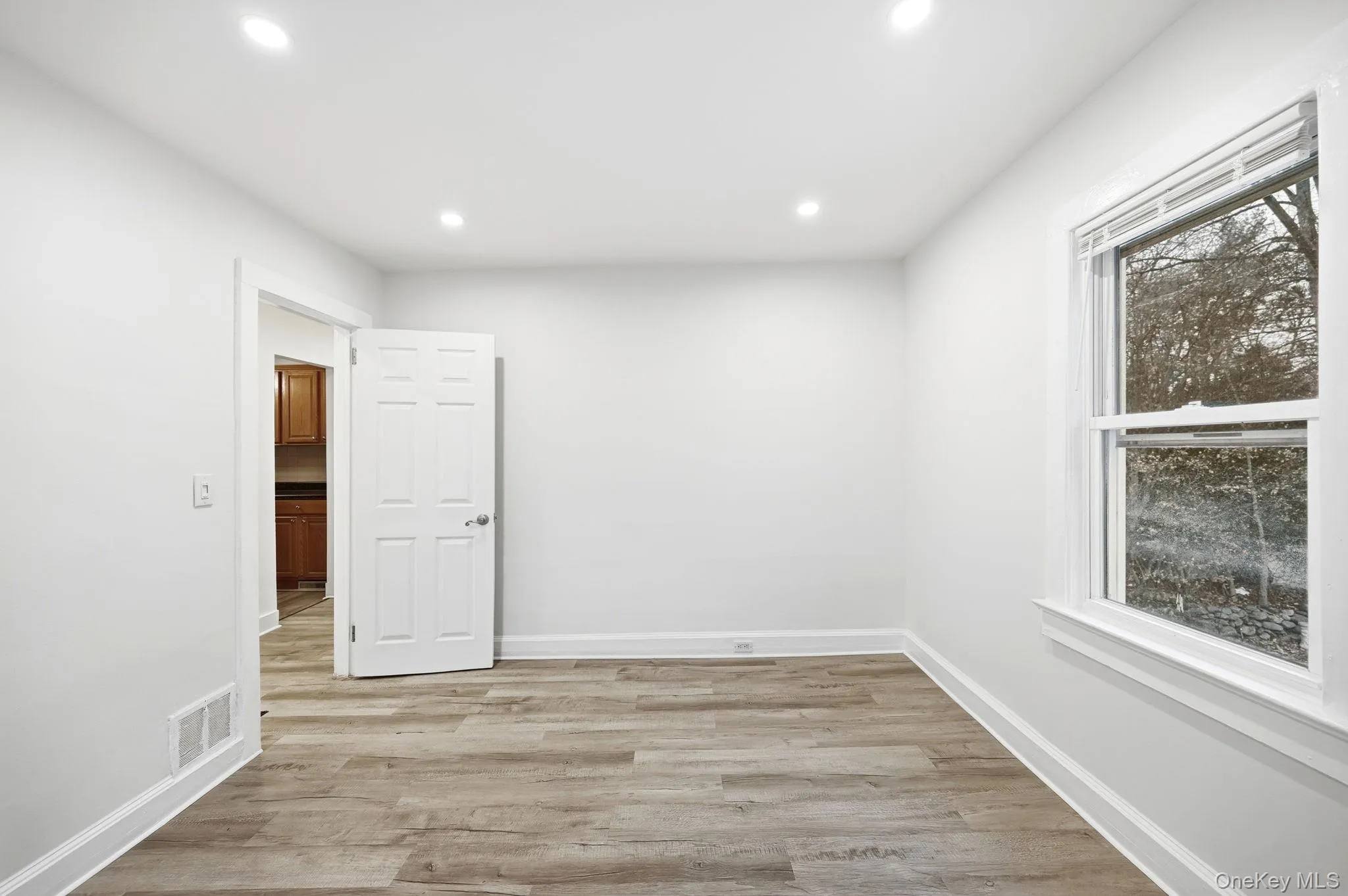 Empty room featuring light wood-style flooring and recessed lighting Empty room featuring light wood-style flooring and recessed lighting