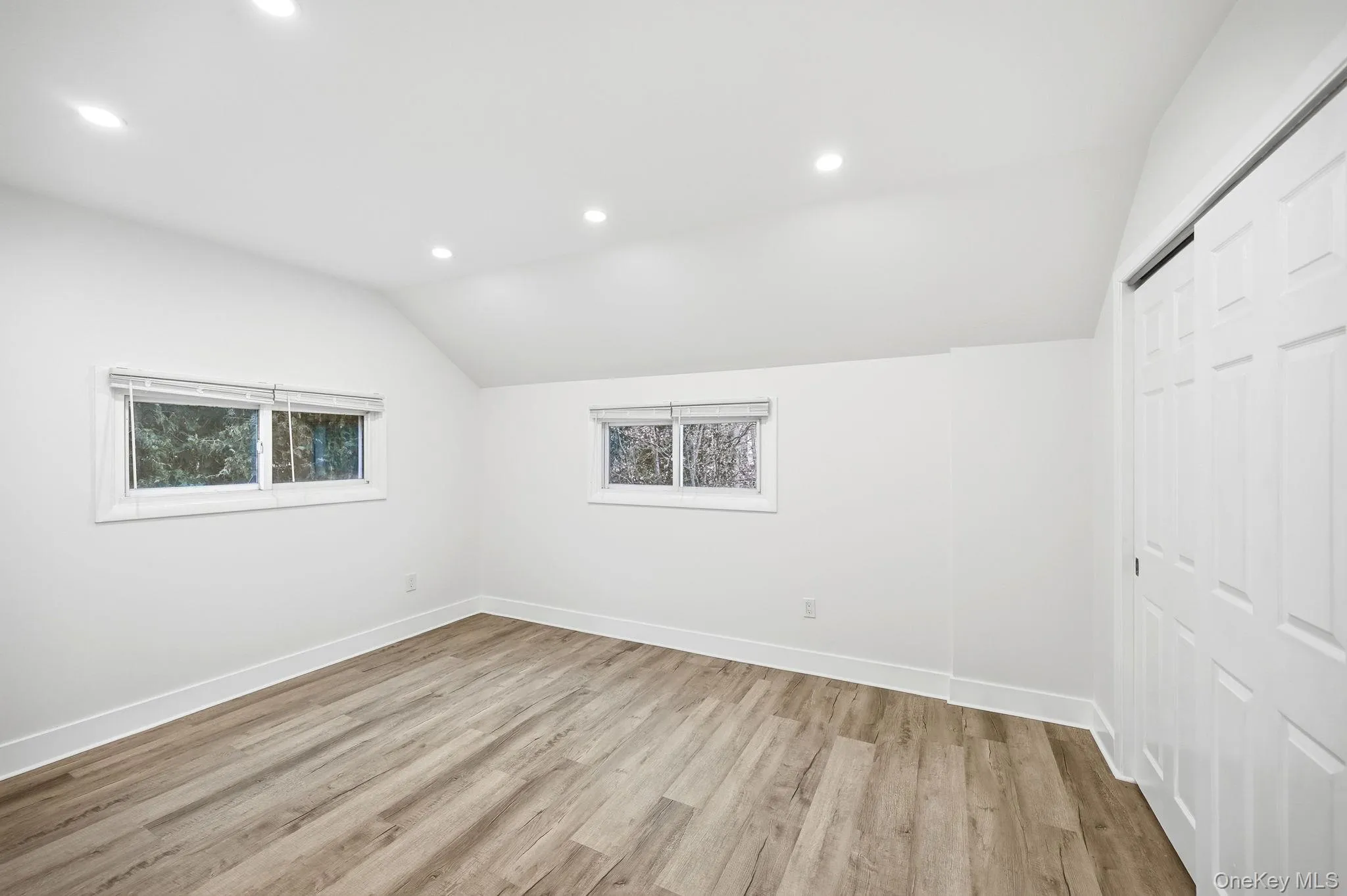 Bonus room with vaulted ceiling, recessed lighting, and light wood-style floors Bonus room with vaulted ceiling, recessed lighting, and light wood-style floors