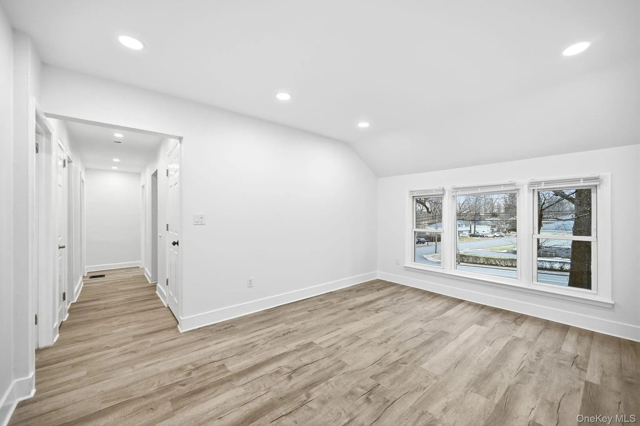 Bonus room featuring light wood finished floors, recessed lighting, and lofted ceiling Bonus room featuring light wood finished floors, recessed lighting, and lofted ceiling