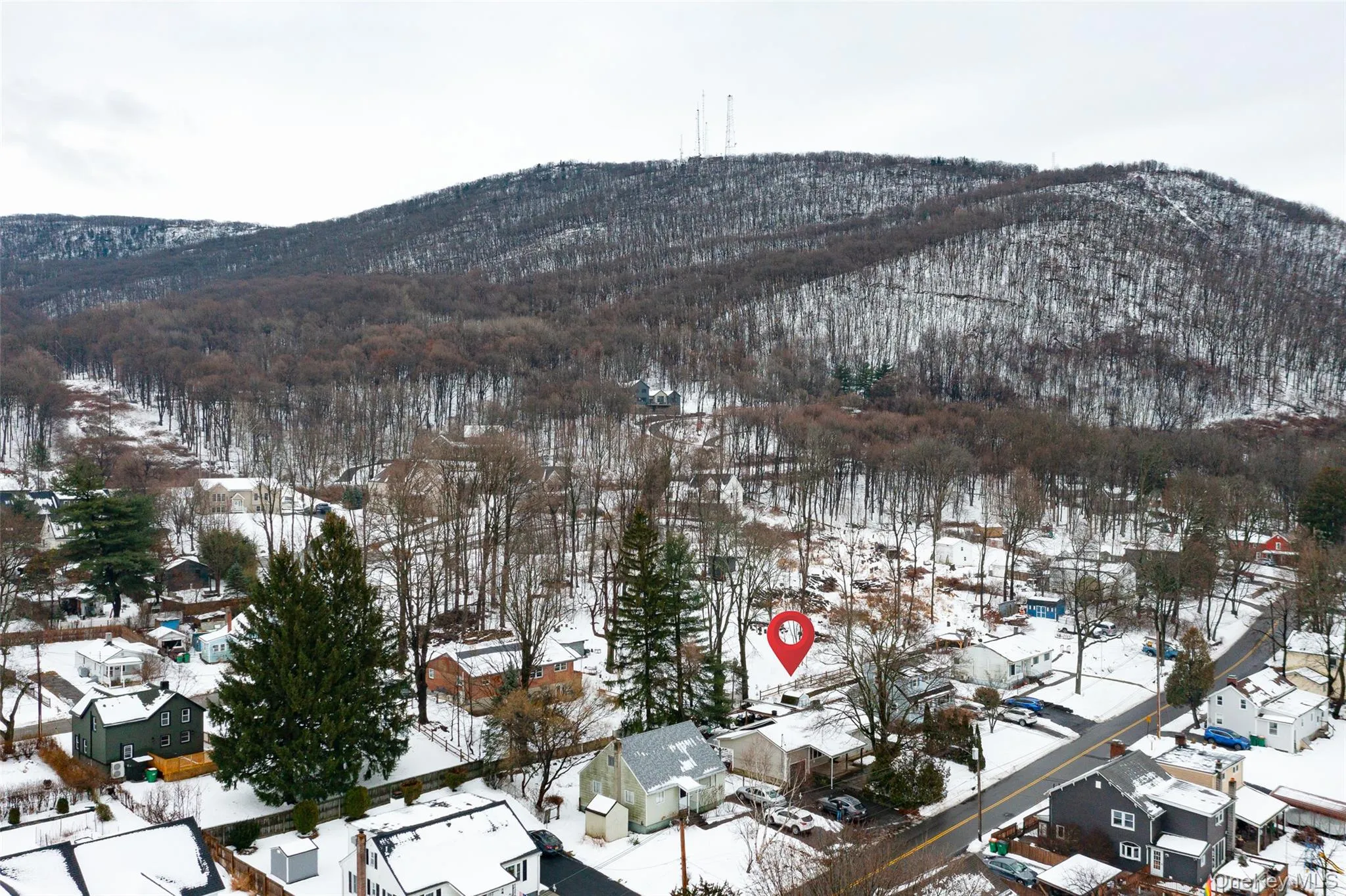 Snowy aerial view with a residential view and a mountain view Snowy aerial view with a residential view and a mountain view
