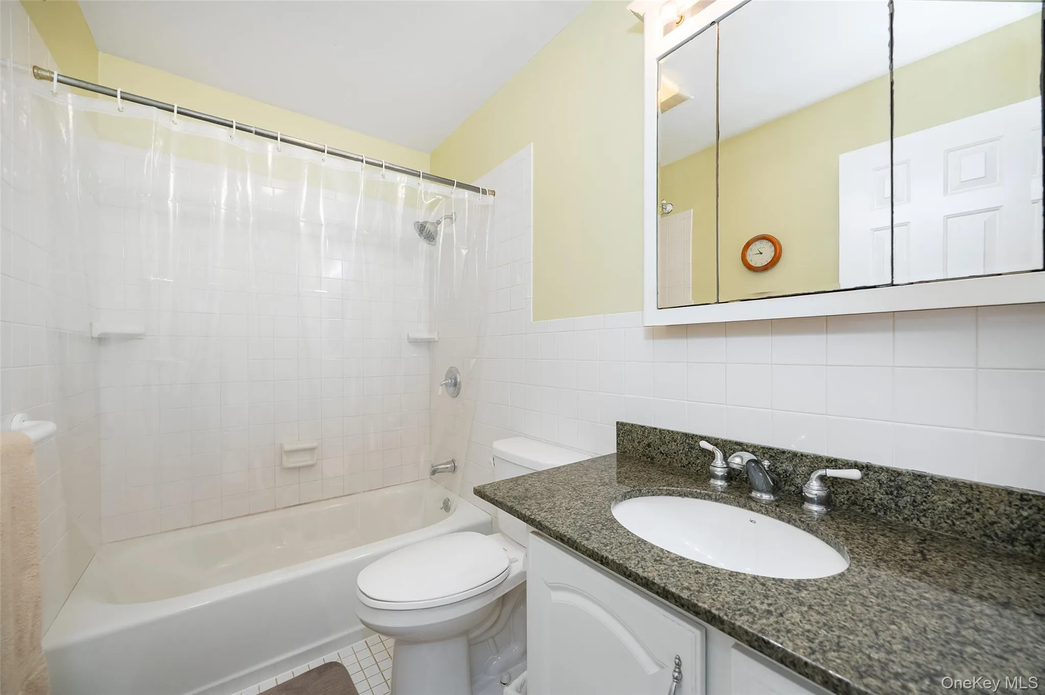 Bathroom with shower / tub combo, tile walls, and vanity Bathroom with shower / tub combo, tile walls, and vanity