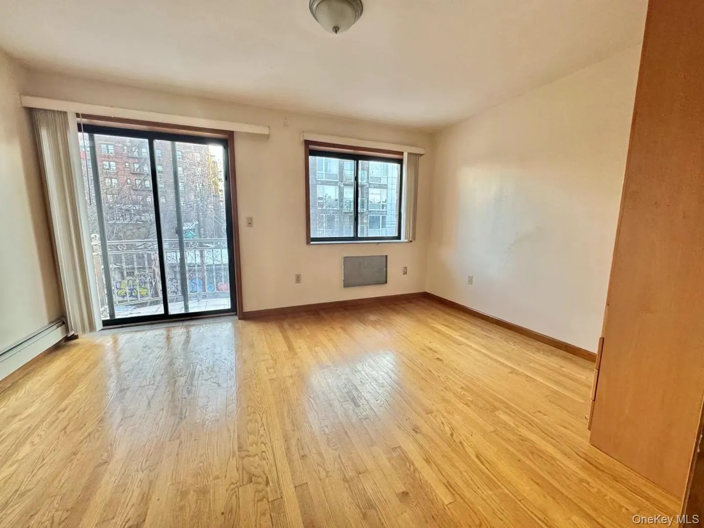 Spare room with light wood-style flooring and baseboards Spare room with light wood-style flooring and baseboards