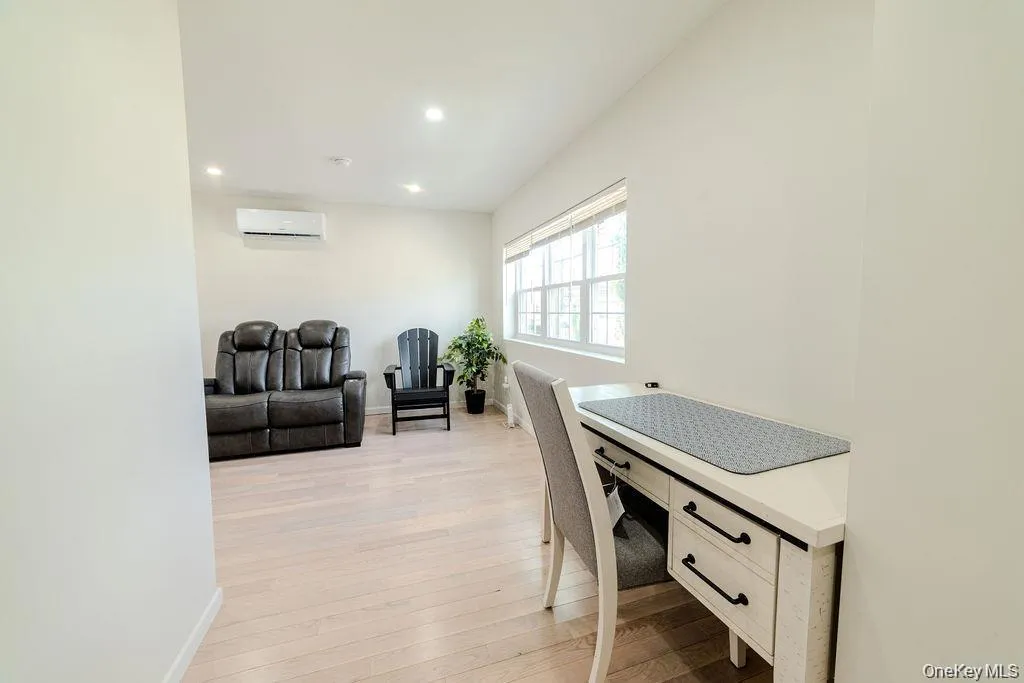 Office featuring light wood-style floors, recessed lighting, and an AC wall unit Office featuring light wood-style floors, recessed lighting, and an AC wall unit
