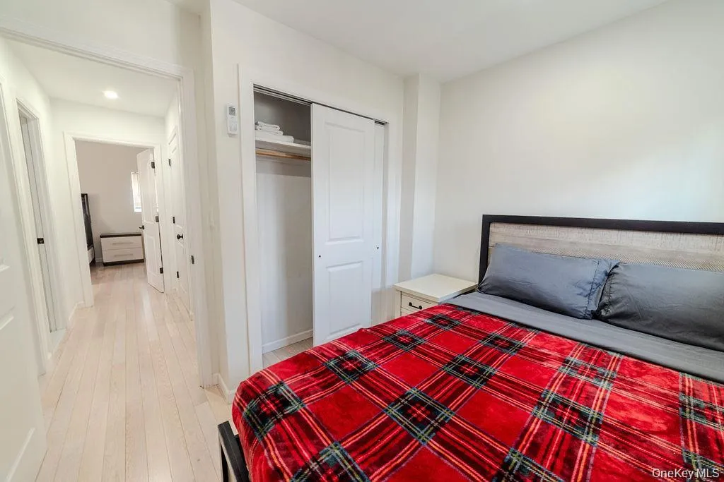 Bedroom with light wood-type flooring and a closet Bedroom with light wood-type flooring and a closet